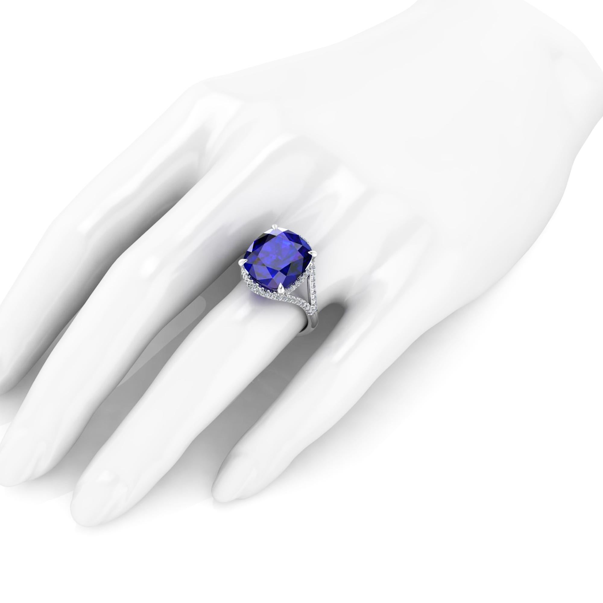 9.23 carat deep blue Tanzinite  GIA Certified, in a one of a kind, hand made Platinum 950, adorned by 0.60 carats of white diamonds pave, designed and conceived in New York City. 
This ring is made to order to guarantee the absolute immaculate