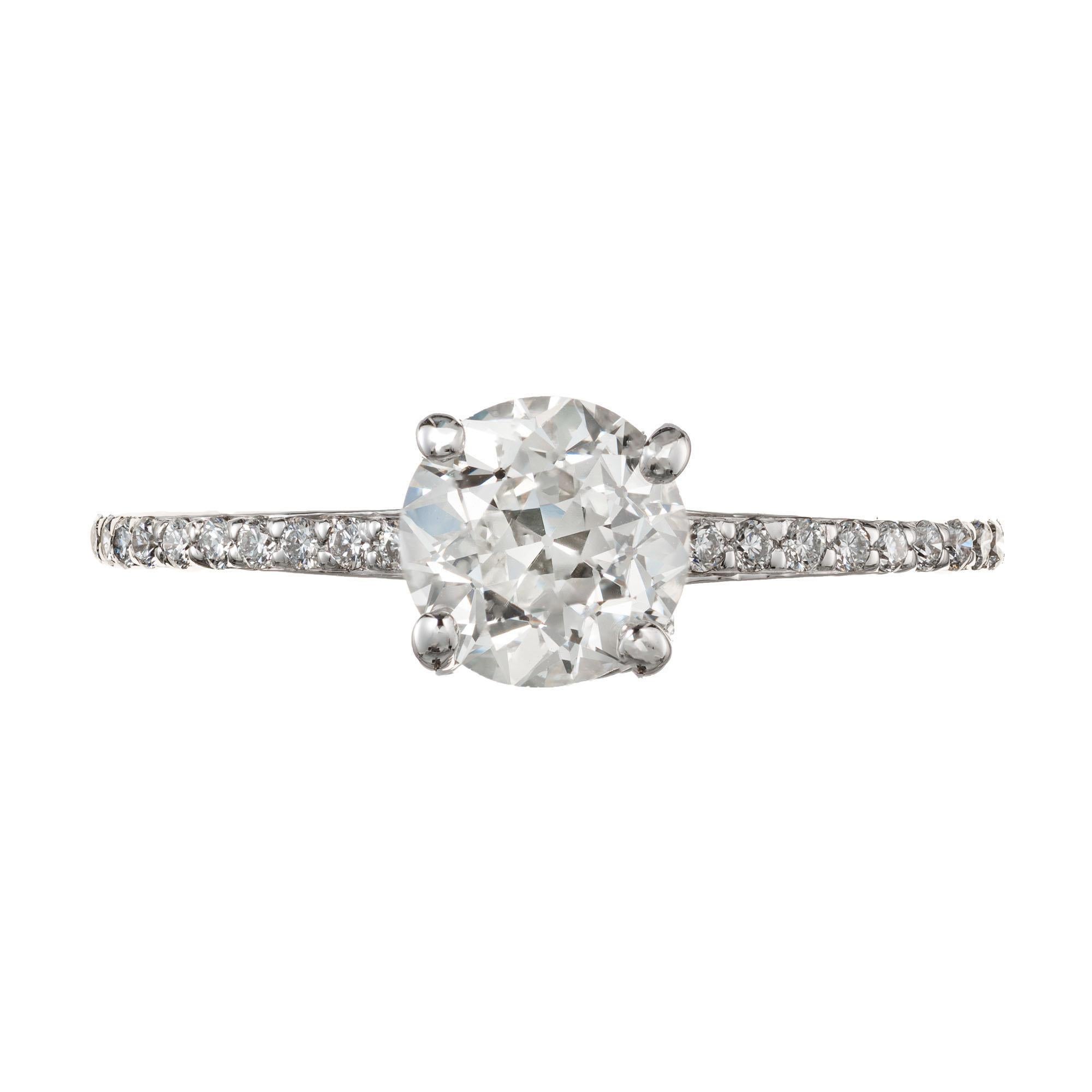1960's round cut diamond engagement ring. One old European cut diamond set in a four prong solitaire setting with 24 round brilliant cut diamonds along both sides of the shank.  

1 Old European cut diamond, approx. .99ct K VVS2 GIA Certificate #
