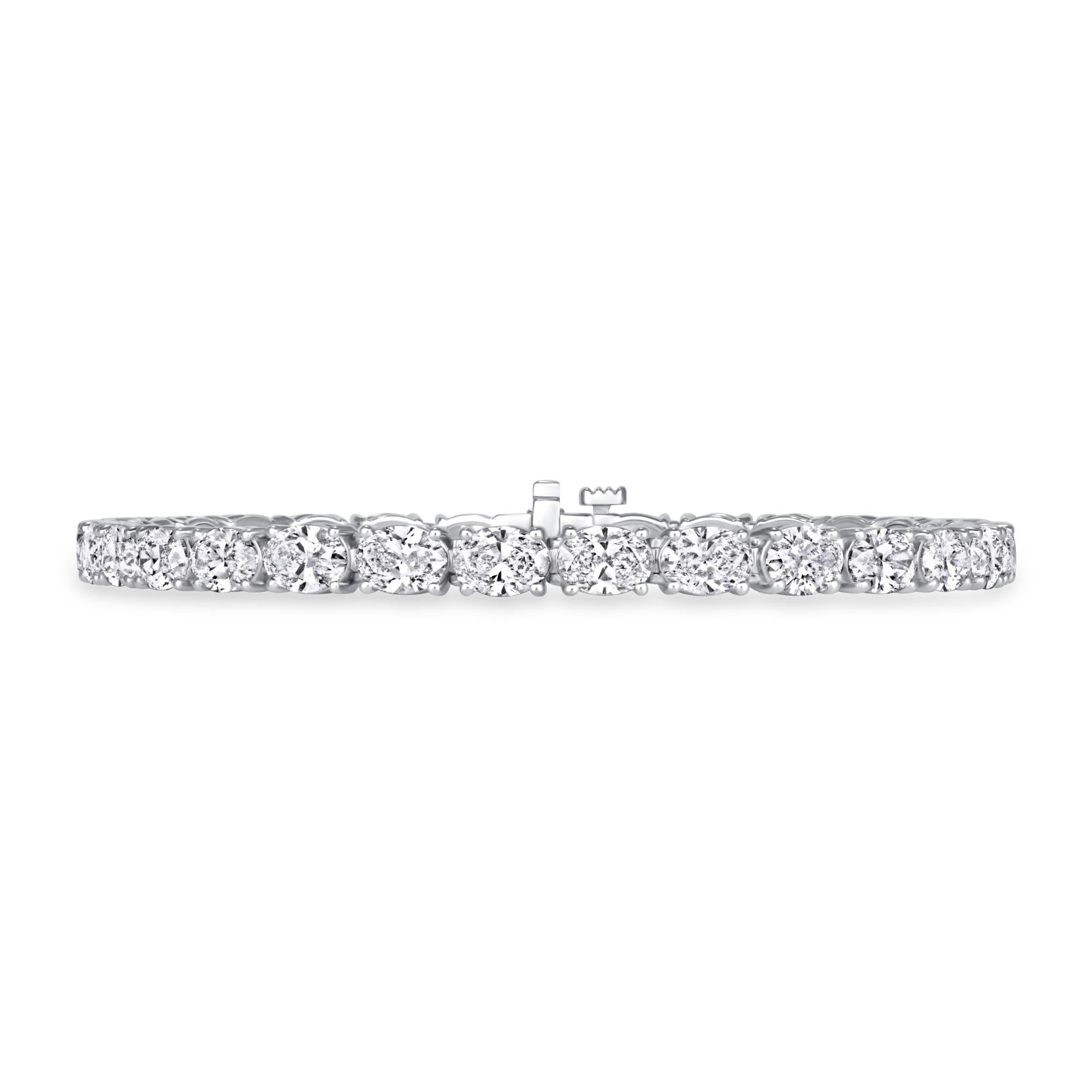 Oval Brilliant Diamond Tennis Bracelet sets in 14K White Gold. This elegant tennis bracelet has thirty-one oval brilliant diamonds GIA certified in D-E-F color, VV-VS clarity with a total weight of 9.90 carats.
