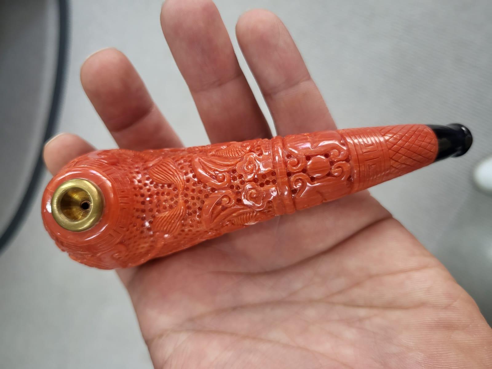 A very gorgeous and one of a kind, pair of Coral Pipes. The first pipe, weighs a total of 105.99 grams. The pipe is reddish - orange in colour, is completely natural, without the presence of any dye. This particular pipe is an assemblage of numerous
