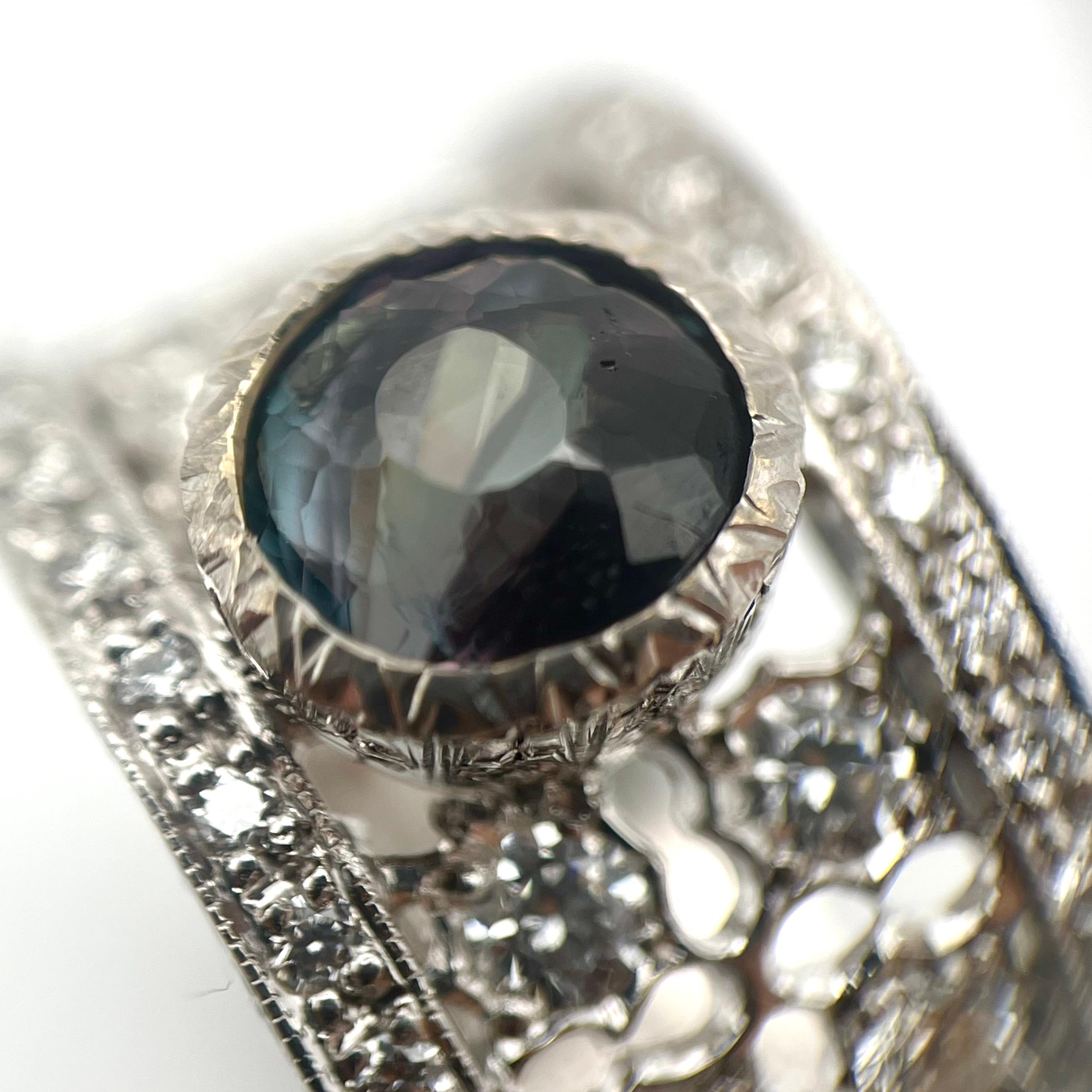 This stunning alexandrite ring is truly one-of-a-kind. Alexandrite possesses a fabulous color-changing phenomenon due to chromium impurities in its crystalline structure. In varying light settings, the alexandrite will change its hue depending on
