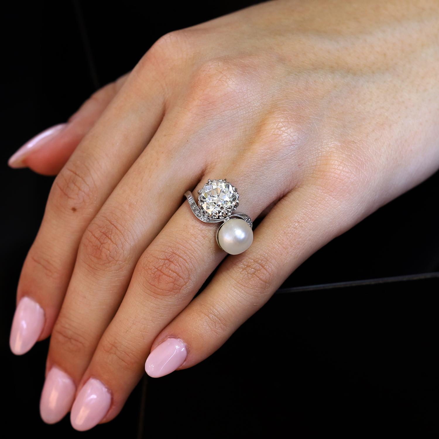 Without a doubt, this Belle Epoque Toi et Moi antique engagement ring is a most romantic treasure. Bold and beautiful, pairing a large, chunky and seductively warm 3.21 carat old European round diamond along with a charming and lustrous natural