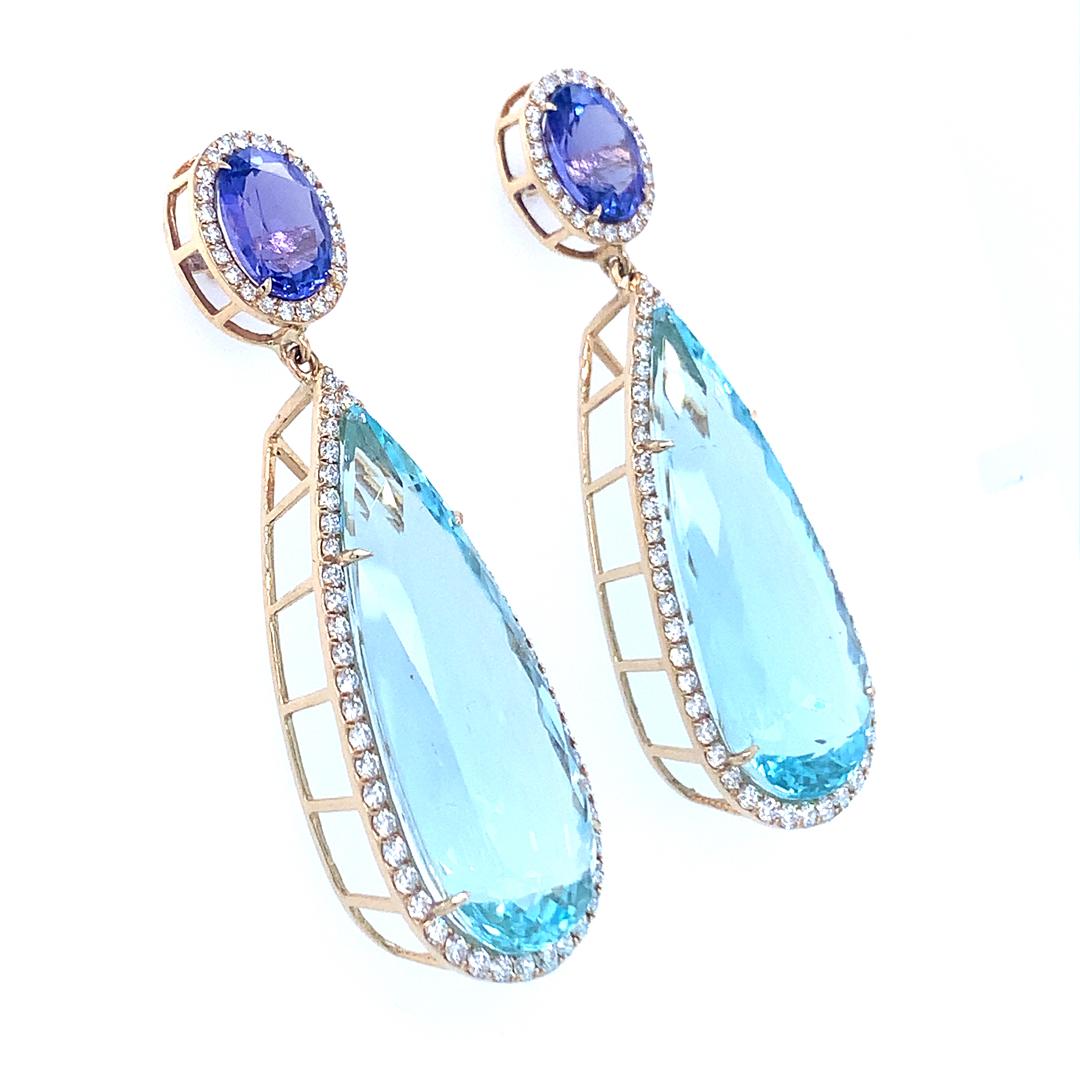 A 38.11 carat pear-shaped Aquamarine, a 3.99 carat round Tanzanite, and a 1.62 carat VS quality diamond dangle drop earring set in 18 Kt white gold are all natural gemstones that are GIA certified. 

