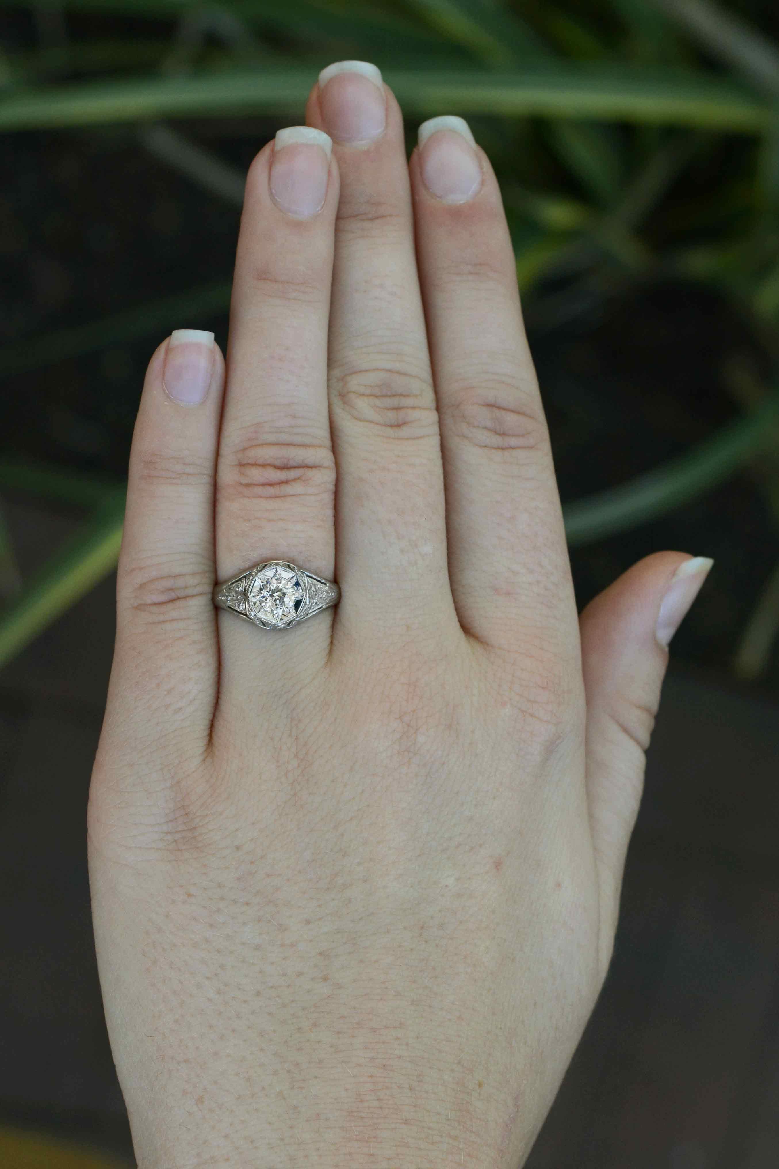An authentic Art Deco filigree diamond engagement ring with a lively and bright half carat old European cut brilliant center. GIA certified as near-colorless, this circa 1920s original antique platinum stunner really allows you to experience the
