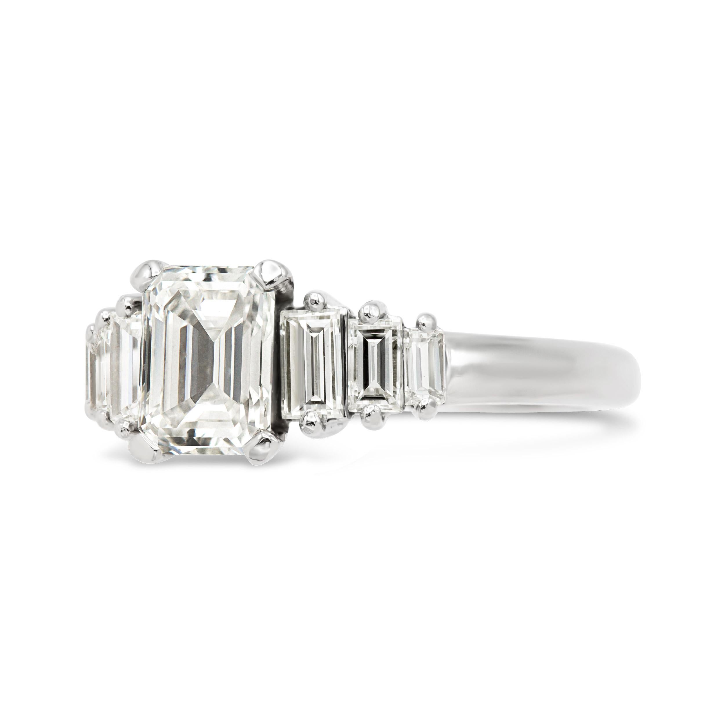 An excellent choice for those looking for a vintage emerald cut engagement ring. This art deco era style features a stunningly bright GIA certified G color emerald cut, flanked by six vertically set step cut diamonds. The generous finger coverage,