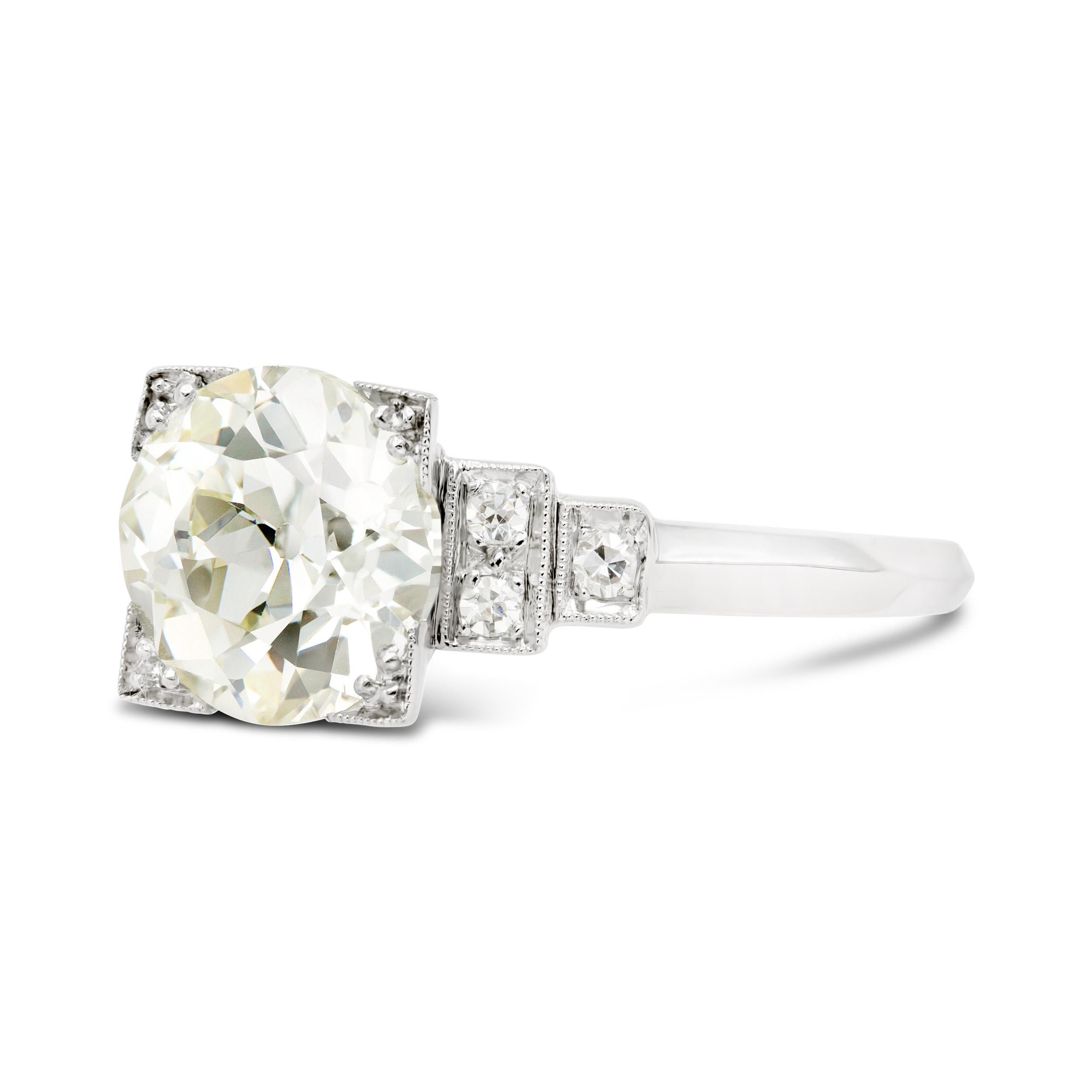 An amazing deco-era engagement ring that screams vintage charm. A 2.23 carat old European cut diamond, graded N VS1 by GIA, has great proportions and looks super bright in this geometric platinum setting. A perfect 2 carat engagement ring option for