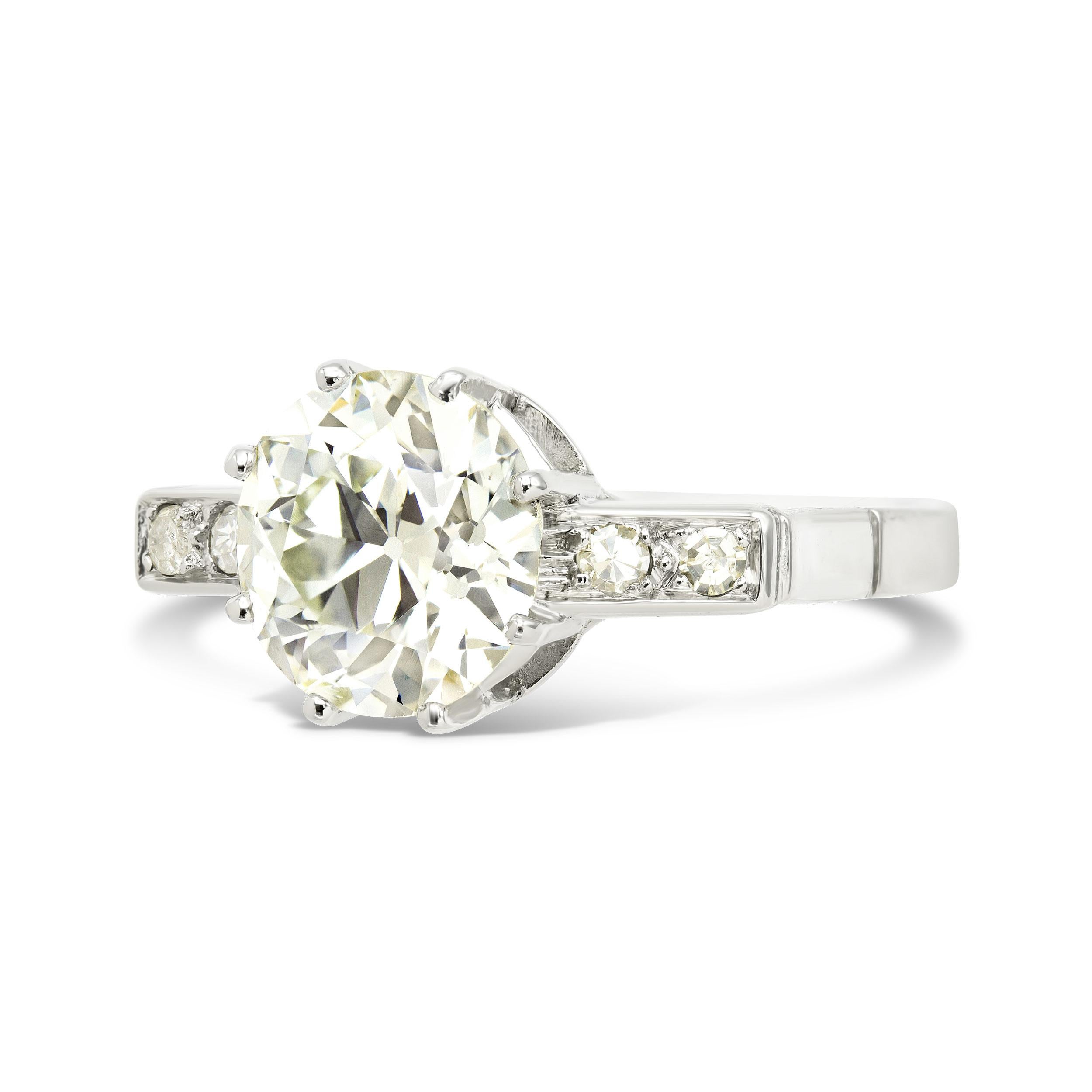An antique old European cut diamond set in a classic Art Deco era setting, this engagement ring is the real deal. Our center is a GIA certified 2.69 ct. diamond with all the charm of an old Euro - with a large culet and blocky facets it throws light