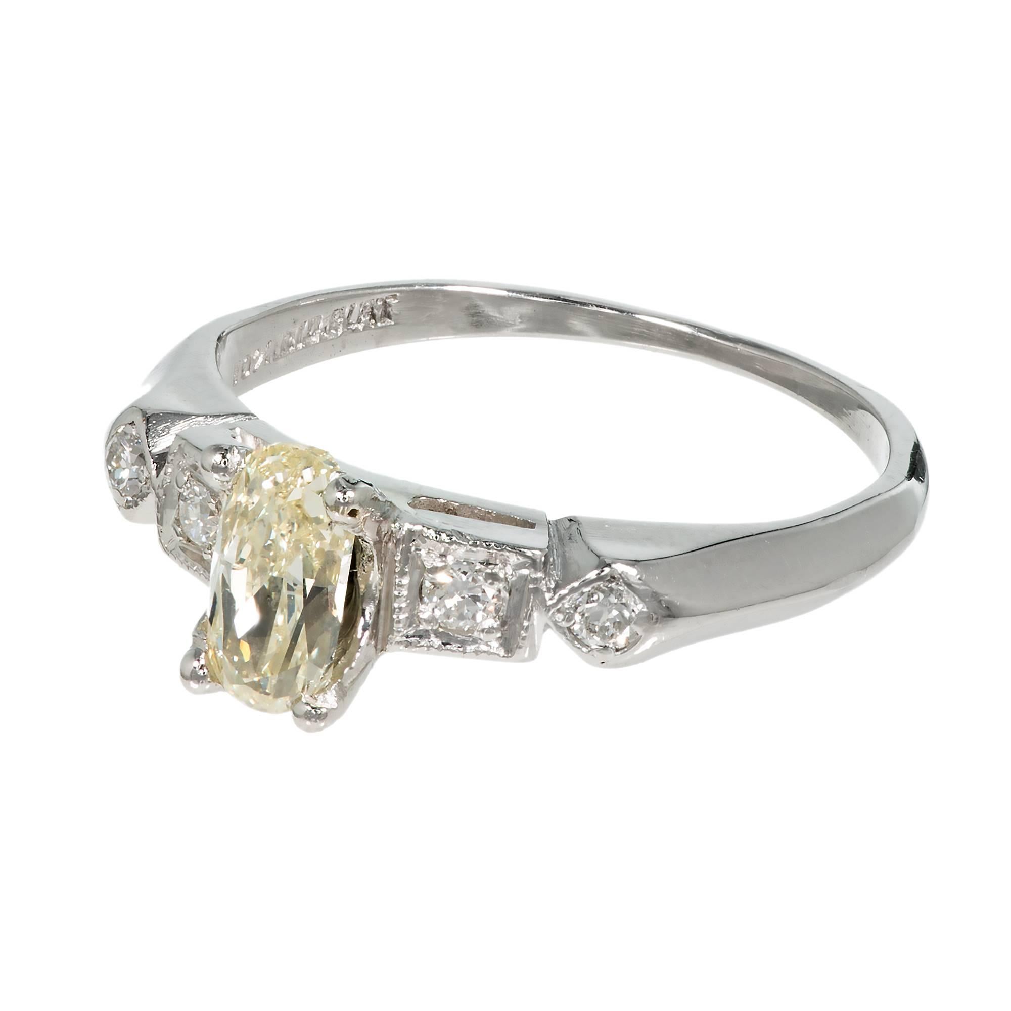 Original Art Deco 1930s light yellow diamond engagement ring. GIA certified natural yellow diamond center stone with 4 round accent diamonds in a platinum setting.  

1 oval light yellow diamond, approx. total weight .57cts, W-X, SI2, 6.64 x 3.49 x