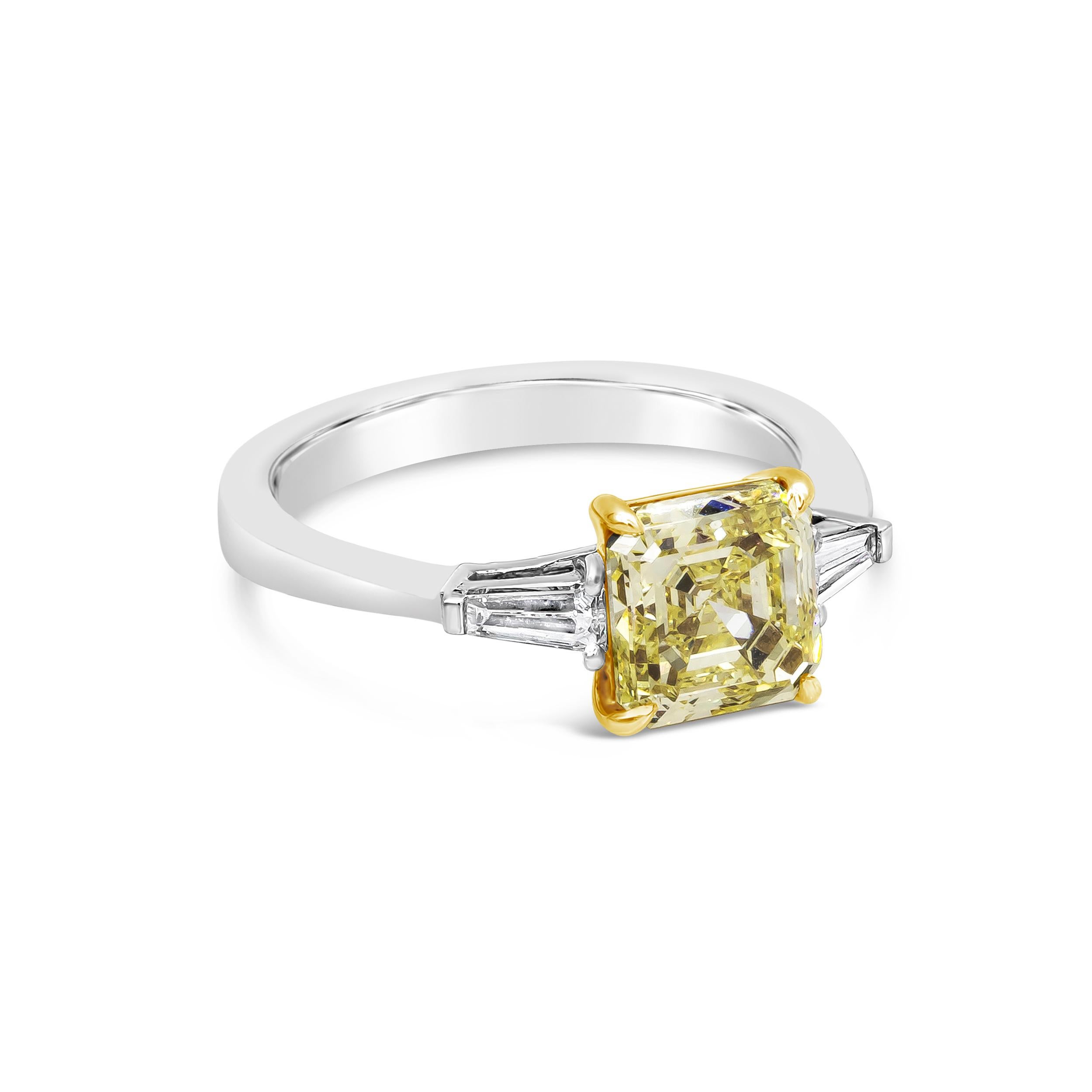 Showcasing a color-rich asscher cut yellow diamond weighing 2.13 carats, flanked by two tapered baguette diamonds weighing 0.24 carats total, set in a polished platinum mounting. GIA certified the center diamond as Fancy Yellow color, Internally