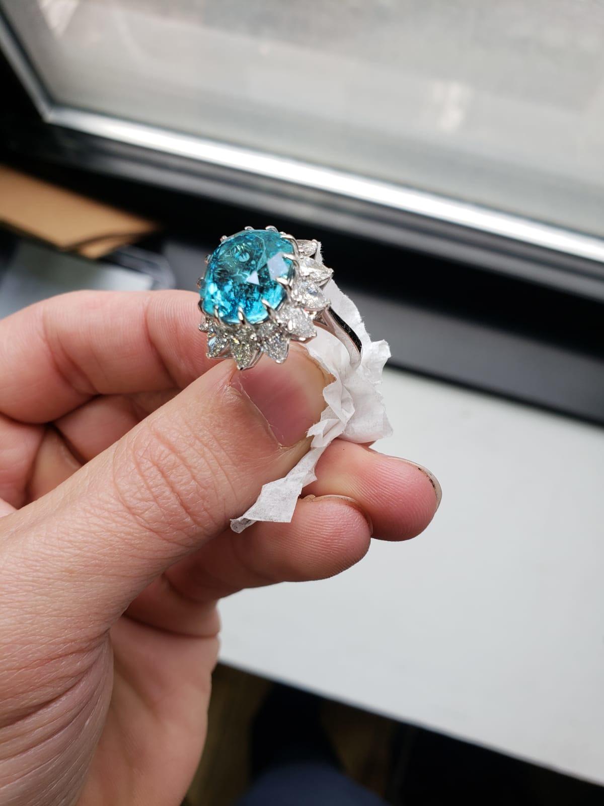 This stunning hand made ring has a superlative 8.25 carat cushion cut paraiba tourmaline that displays its brilliant aqua color in this contemporary and romantic ring. 

Paraiba tourmalines are among the most exciting gemstones in the world, and