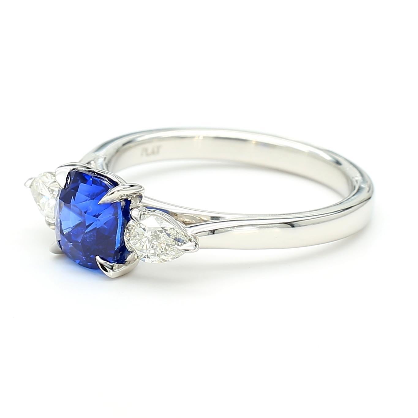 RareGemWorld's beautiful GIA certified sapphire ring. Mounted in a beautiful Platinum setting with a natural cushion cut blue sapphire. The sapphire is surrounded by two natural pear cut white diamonds. This ring is guaranteed to impress and enhance