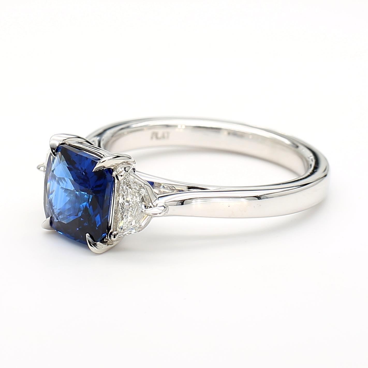RareGemWorld's beautiful GIA certified sapphire ring. Mounted in a beautiful Platinum setting with a natural cushion cut blue sapphire. The sapphire is surrounded by two natural epaulette cut white diamonds. This ring is guaranteed to impress and