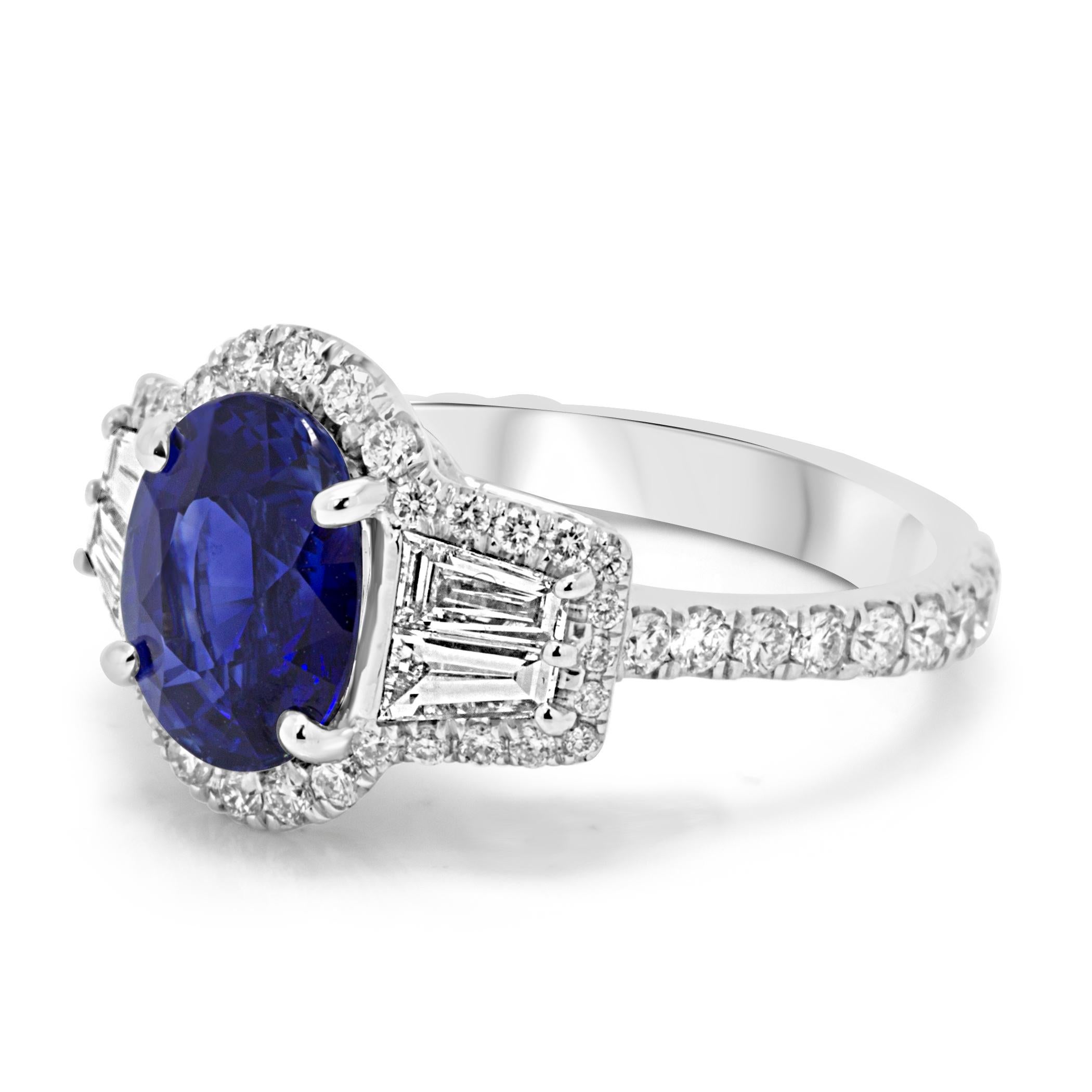 Super Gorgeous GIA Certified Blue Sapphire Oval 3.34 Carat  Flanked by 4 White Diamond Baguettes on the side 0.53 Carat encircled in a Single Halo of White Round Diamonds 0.79 Carat in Hand Made 18K White Gold Ring.

Style available in different