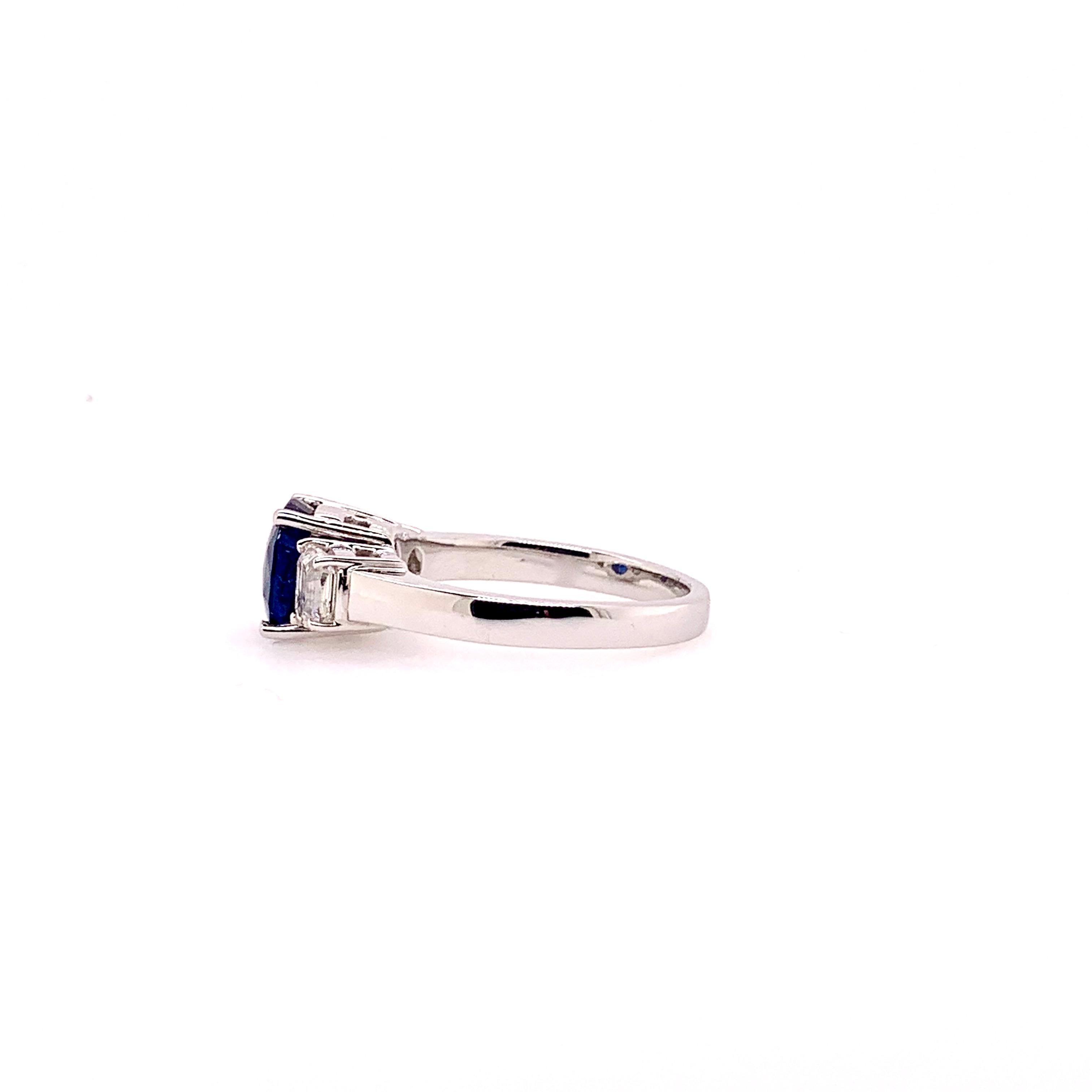 A gorgeous 3 stone sapphire and diamond ring in 18k white gold.  The ultimate classic that belongs in every family collection.  The GIA certified, heated blue sapphire is 2.39 cts and has 0.76 cts total weight of half moon cut diamonds. 

Ring Size