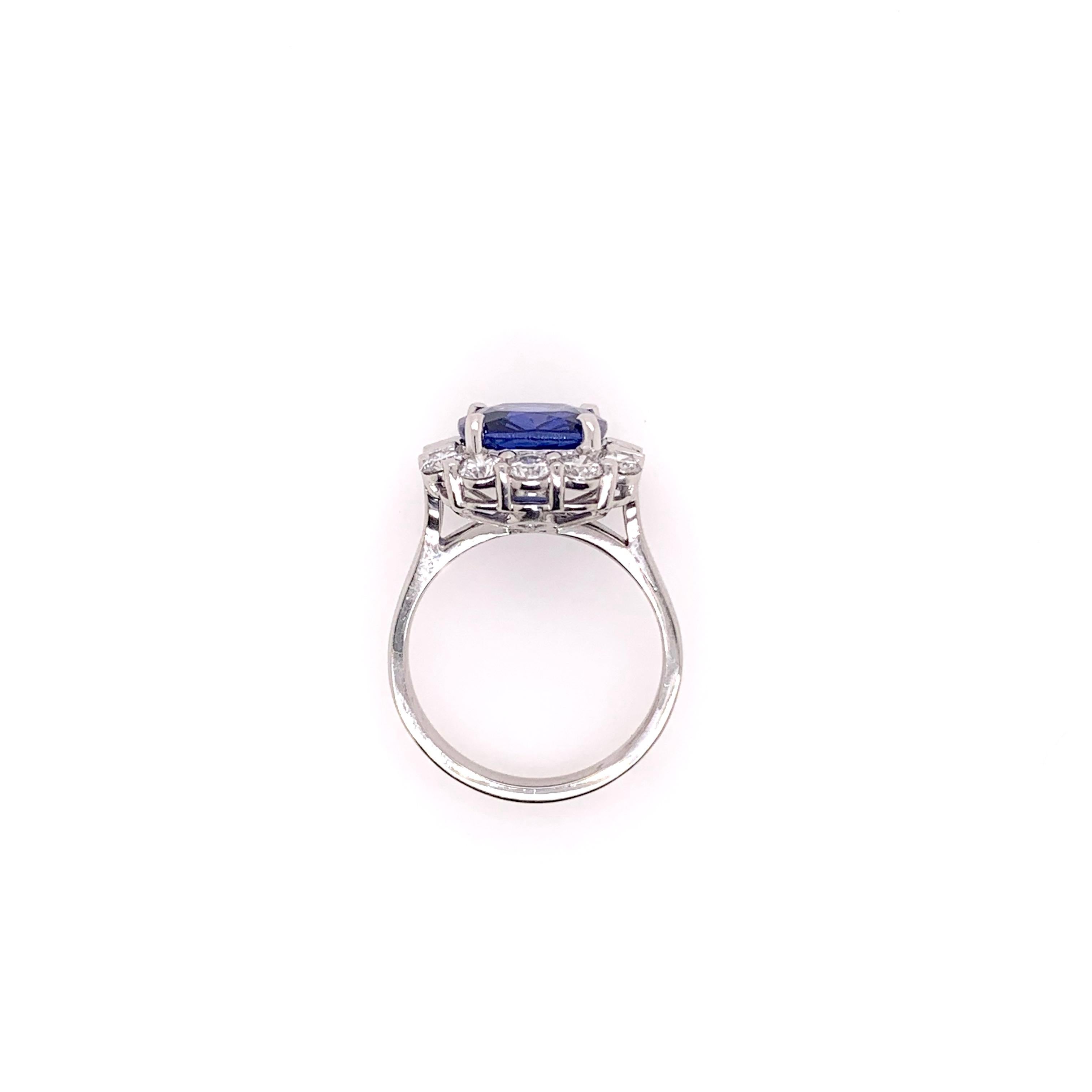 A slight twist to the classic sapphire style with this unique, handmade ring in platinum.  The GIA certified heated sapphire is 5.25 carats and boasts 1.34 carats of round brilliant and baguette cut diamonds.   The baguette diamonds were