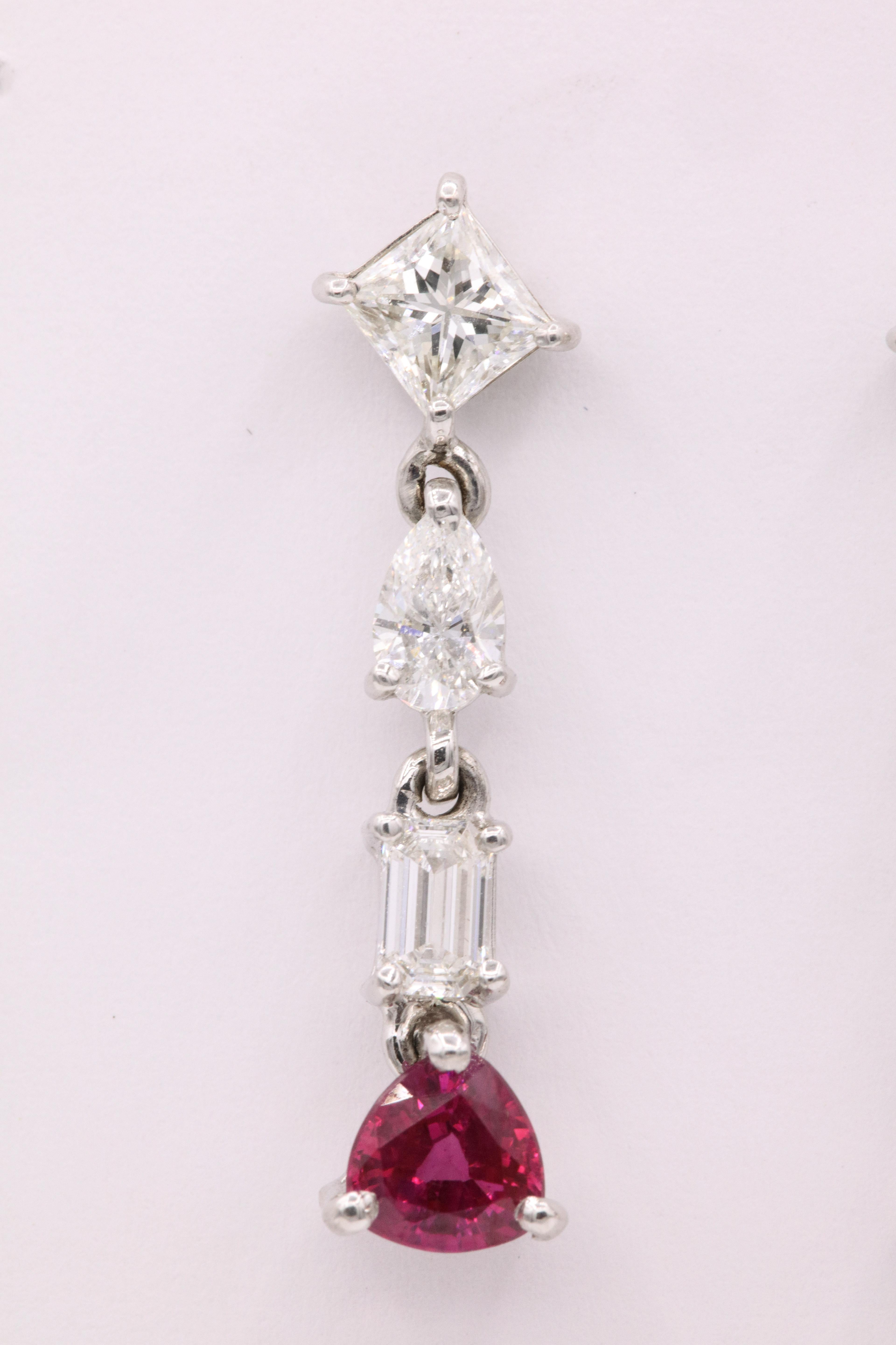 18K White gold drop earrings featuring two triangular Burma Rubies weighing 1.33 carats and three diamonds, princess, pear, and emerald cuts, weighing 2.20 carats. Elegant pair of earrings!
Color G-H
Clarity VS-SI
GIA Certified 
