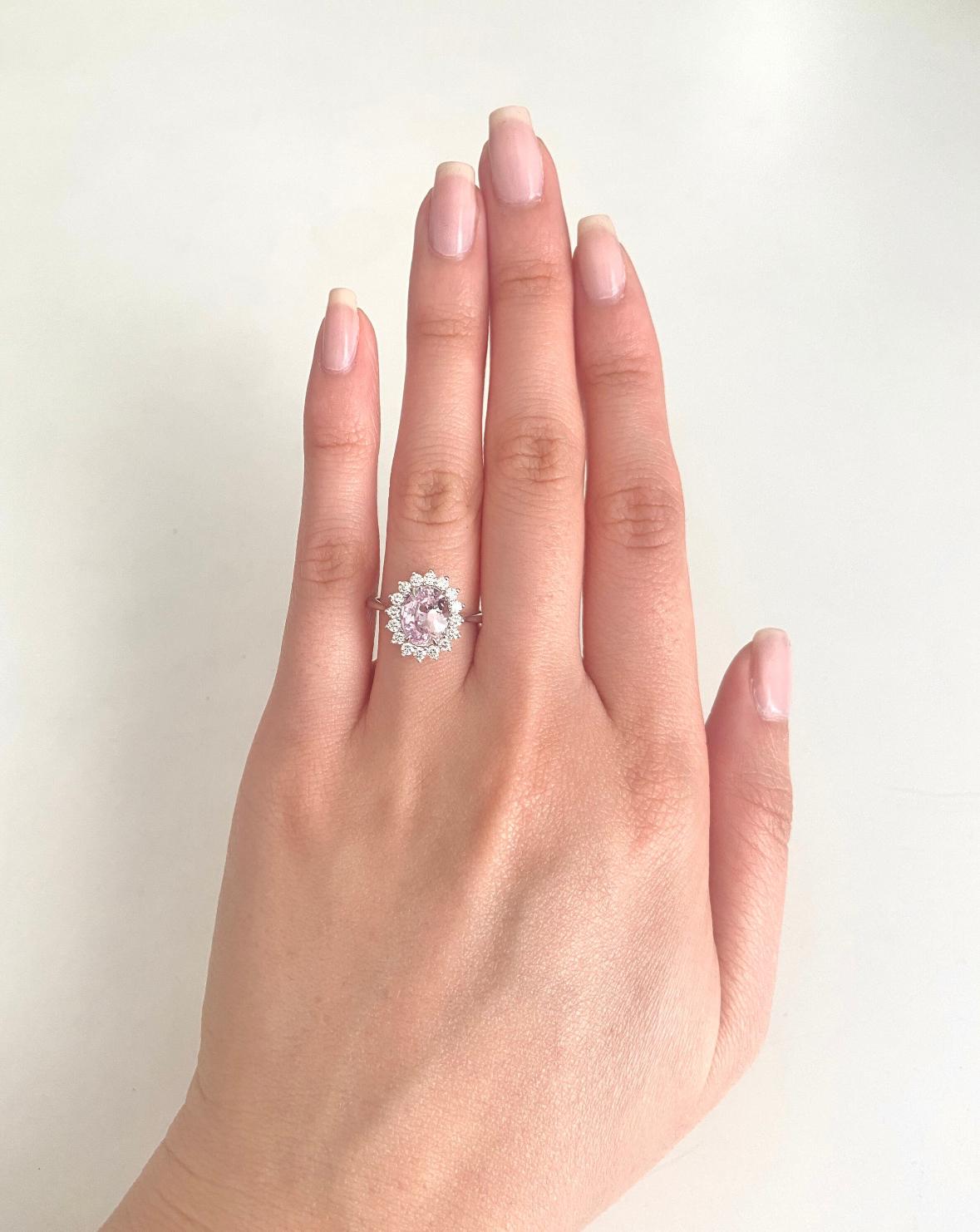 Embrace elegance with this 1.85 carat GIA certified oval unheated pink sapphire diamond halo ring in 14k white gold. The delicate band accentuates the soft, pale pink hue of the sapphire, certified by GIA for authenticity. Surrounded by a sparkling