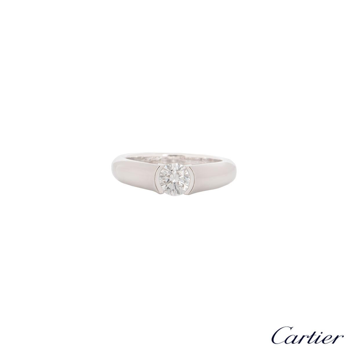 An elegant platinum Cartier diamond engagement ring from the C de Cartier collection. The ring features a round brilliant cut diamond in tension setting with a weight of 0.54ct, G colour and VS1 in clarity. The ring is currently a size UK L, EU 51