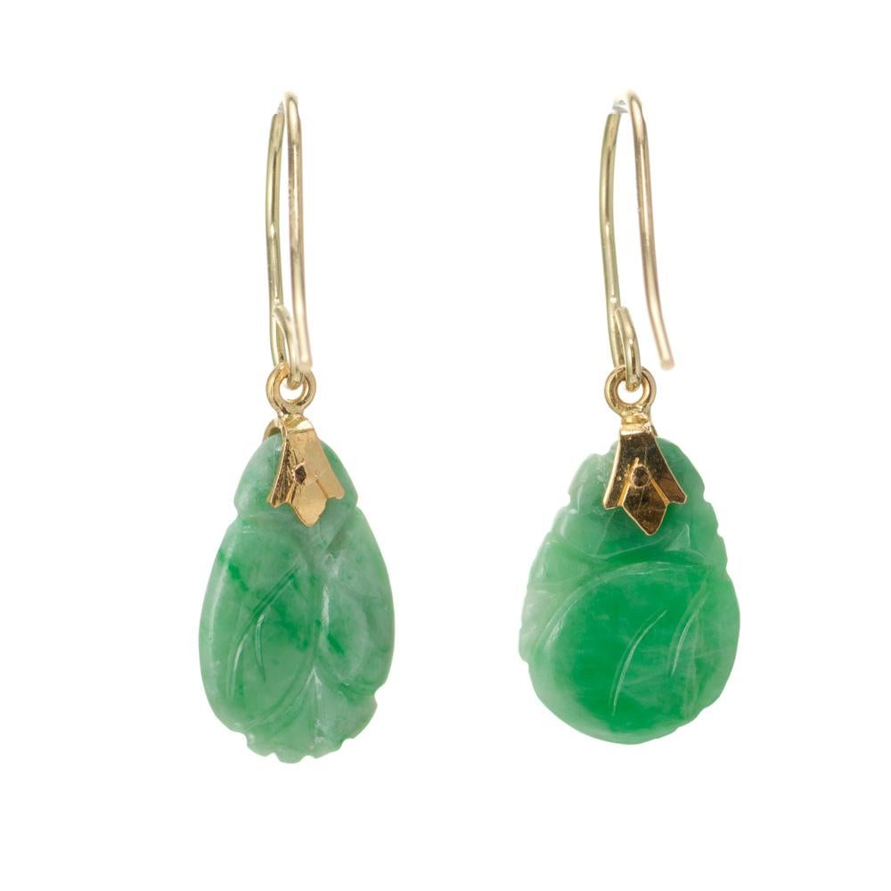 1950's Hand carved Jadeite Jade dangle earrings. GIA certified 2 mottled green pierced carving's with 18k yellow hooks. 

2 mottled pierced carved green jade, 14.09 x 9.94 x 2.33mm GIA Certificate # 2211667637
18k yellow gold
Stamped: 18k on