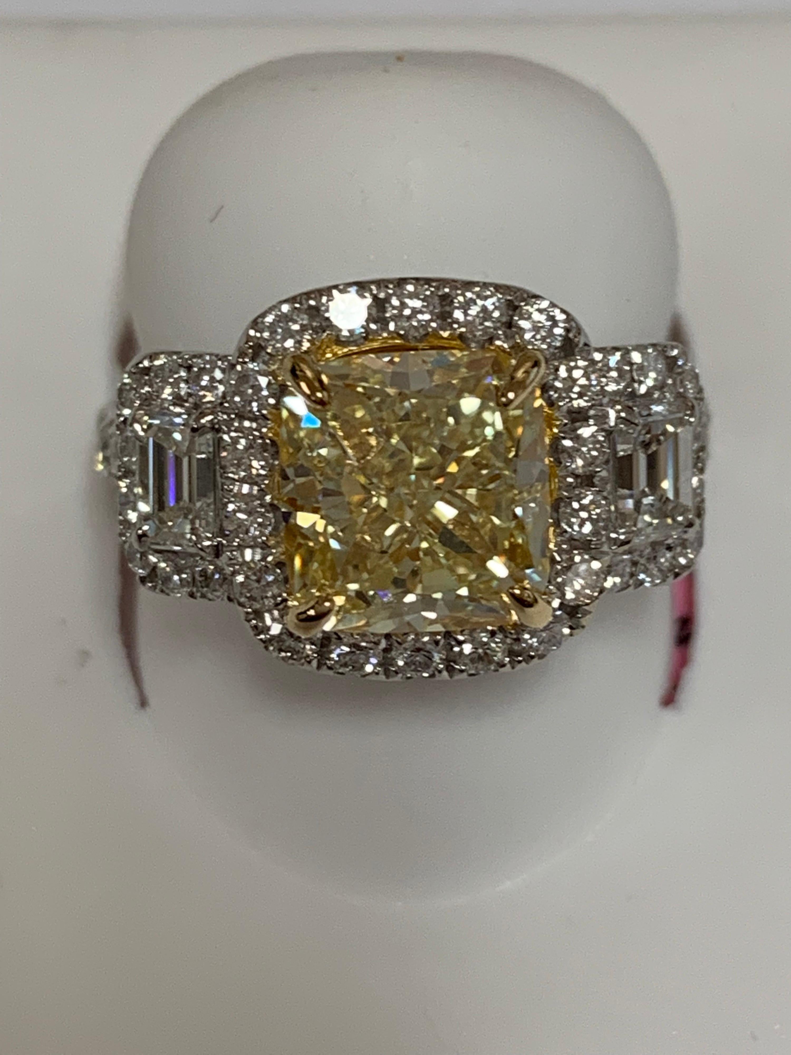 GIA Certified natural yellow Cushion 3.5 carat center stone and additional emerald cut and round 1.21 Carat white diamonds set in 18 karat two tone gold is one of a kind hand crafted ring, The size of the ring is 7 but can be resized if needed.