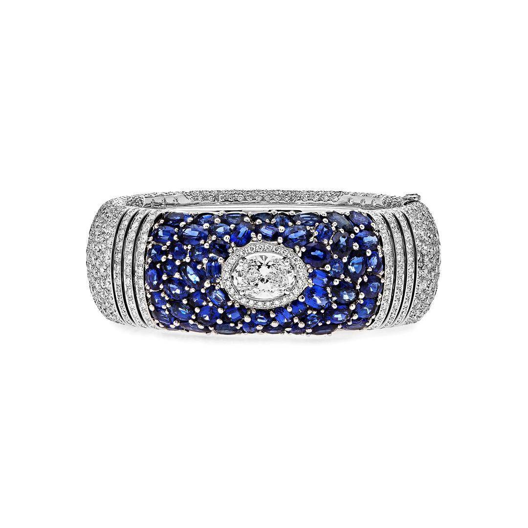 This Chanel Deep Blue Bracelet adorned with captivating sapphires and diamonds is crafted in 18K white gold. The Certified by GIA for its exceptional quality, a stunning 2.30-carat E/IF oval diamond center is the main character in this piece.  