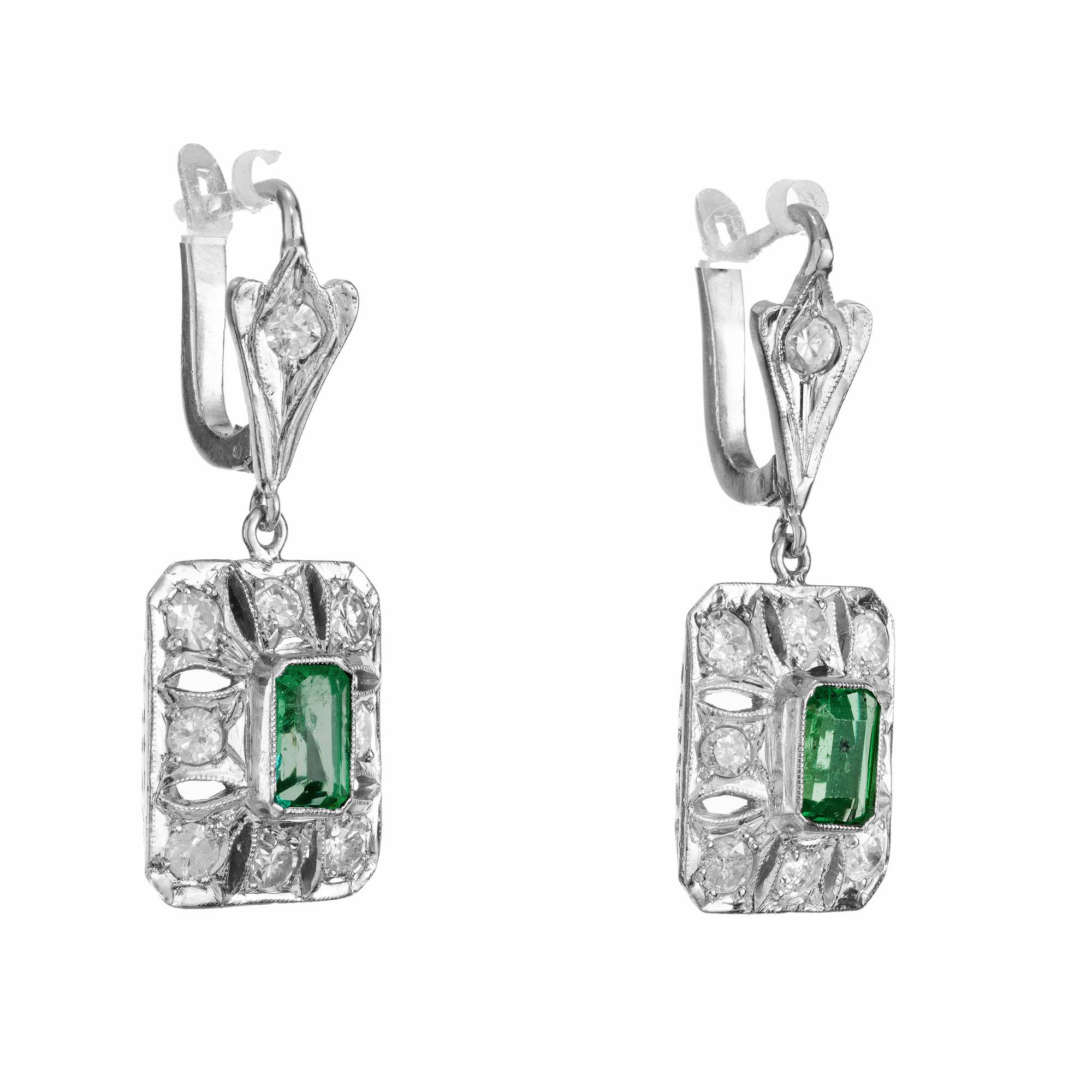 1930's Colombian Emerald Diamond Platinum Dangle Earrings. These stunning earrings are a true testament to the allure and elegance of Colombian emeralds as the platinum filigree settings are to the Art Deco era. 2 octagonal cut emeralds with an