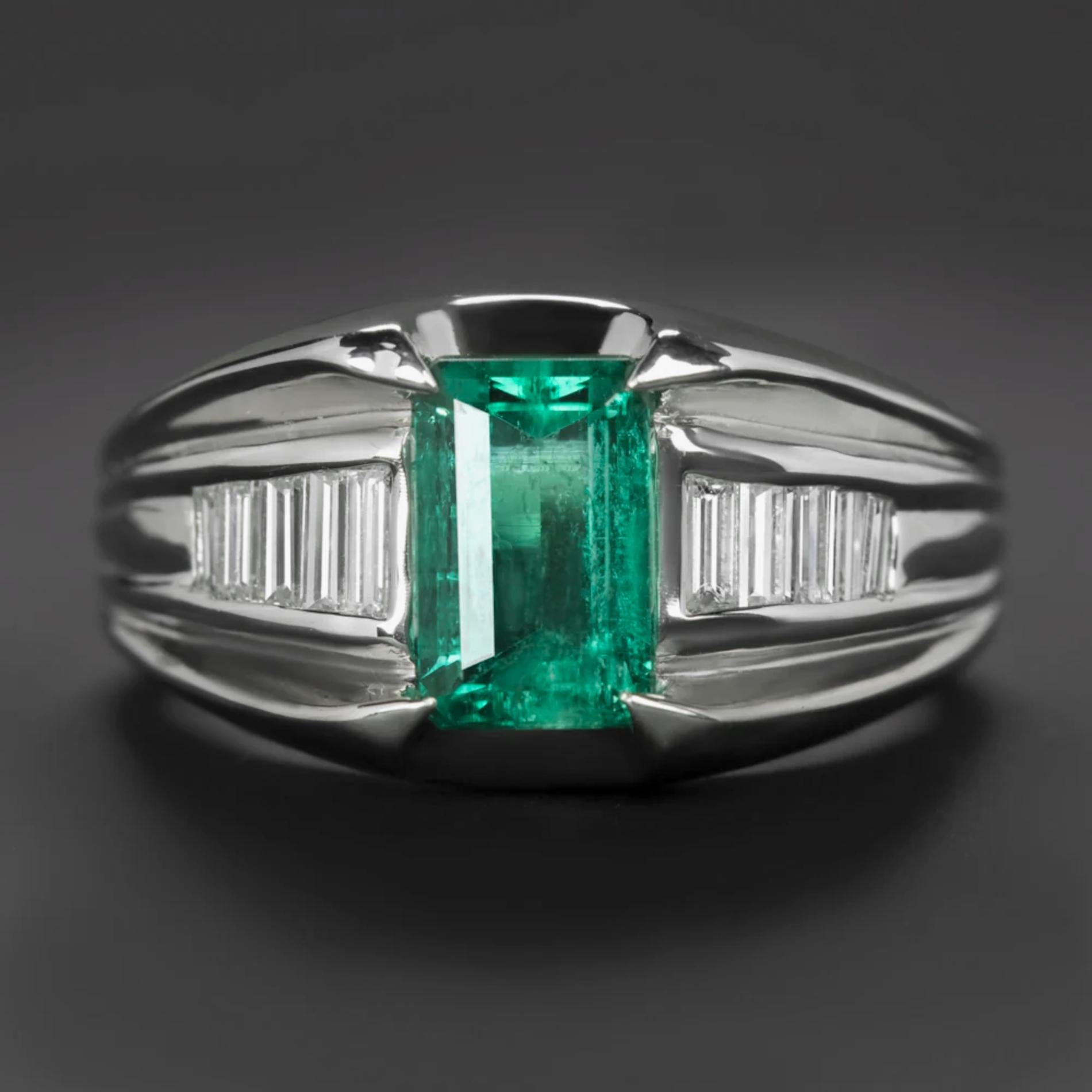 This captivating ring showcases an emerald cocktail ring features a very high quality GIA certified Colombian emerald in a chunky platinum setting with baguette cut diamond accents! The ring offers a luxurious, eye catching look with rich color and