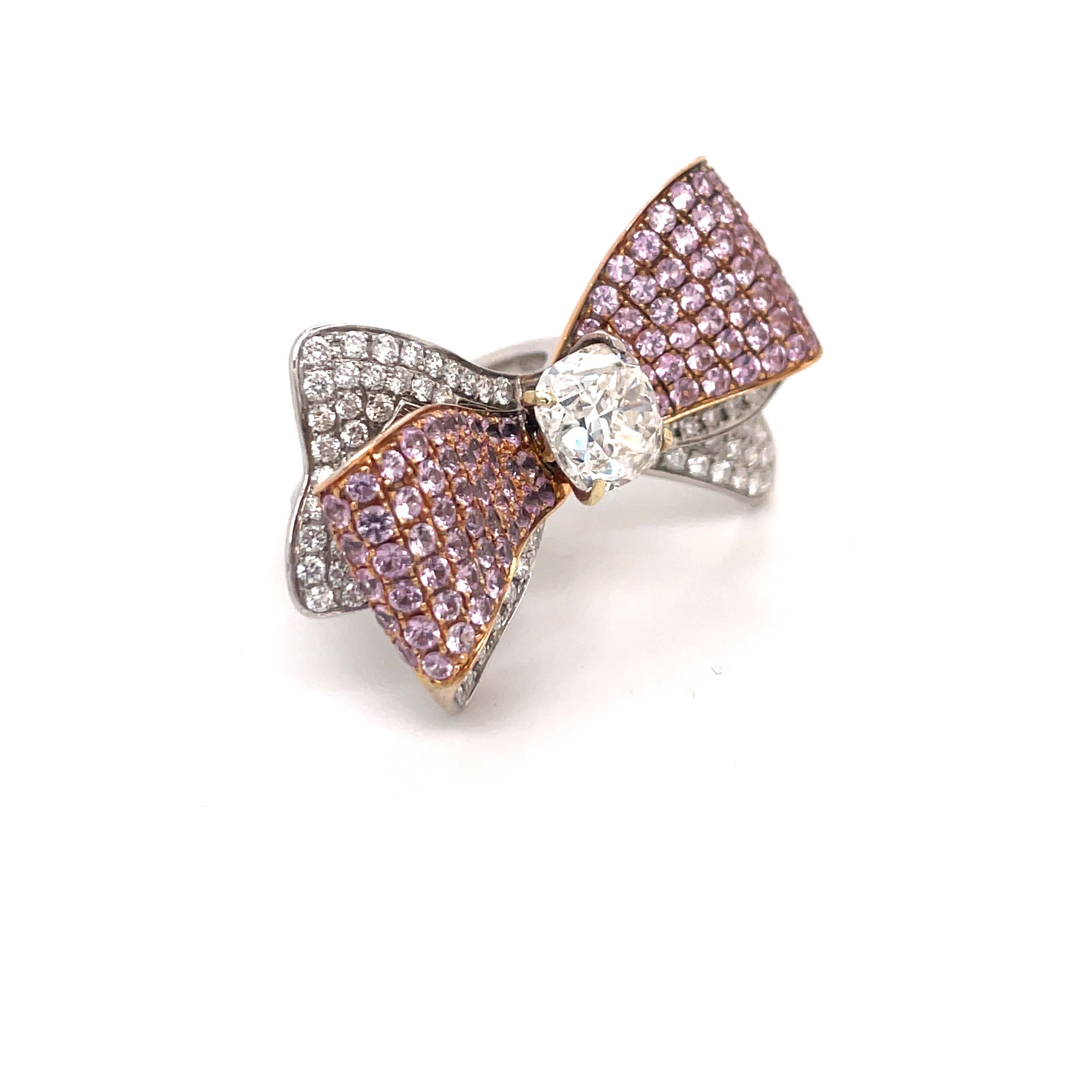 One fashionable Bow motif ring featuring a GIA Certified Cushion Brilliant weighng 3.01 Carats Color I Clarity VS1 flanked with pink Sapphires weighing 3.50 carats and round brilliants weighing 1.63 carats. 
GIA Certificate # 16357993