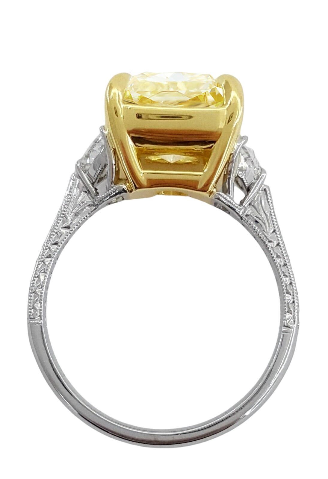 An exquisite  5 carat Cushion Brilliant Cut Natural Yellow Diamond Three Stone Engagement Ring in Platinum & 18K Yellow Gold. 


