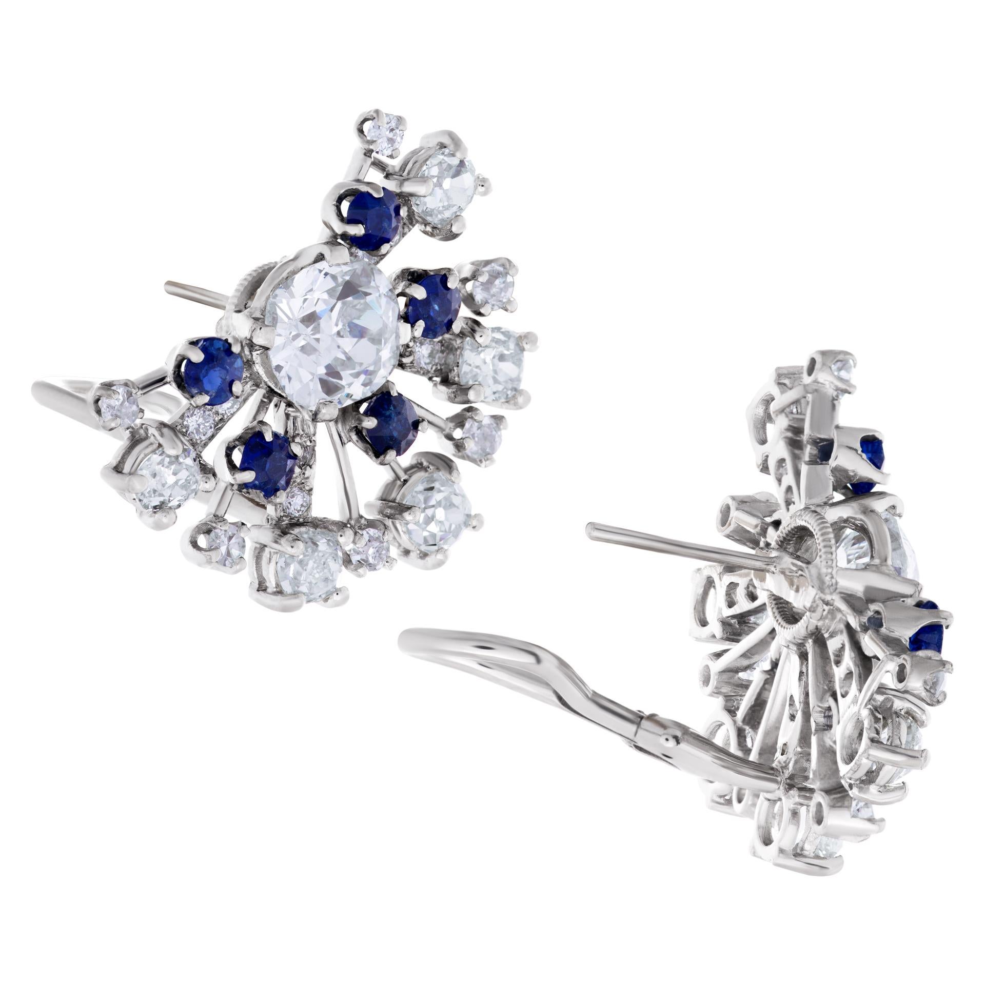ESTIMATED RETAIL: $25,000 YOUR PRICE: $14,500 - GIA certified cushion brilliant diamonds 1.66 carats (I color, SI2 clarity) and 2.03 carat (K color, SI1 clarity) with a fanned earring with round diamonds and blue sapphires in platinum. Width: 1'',