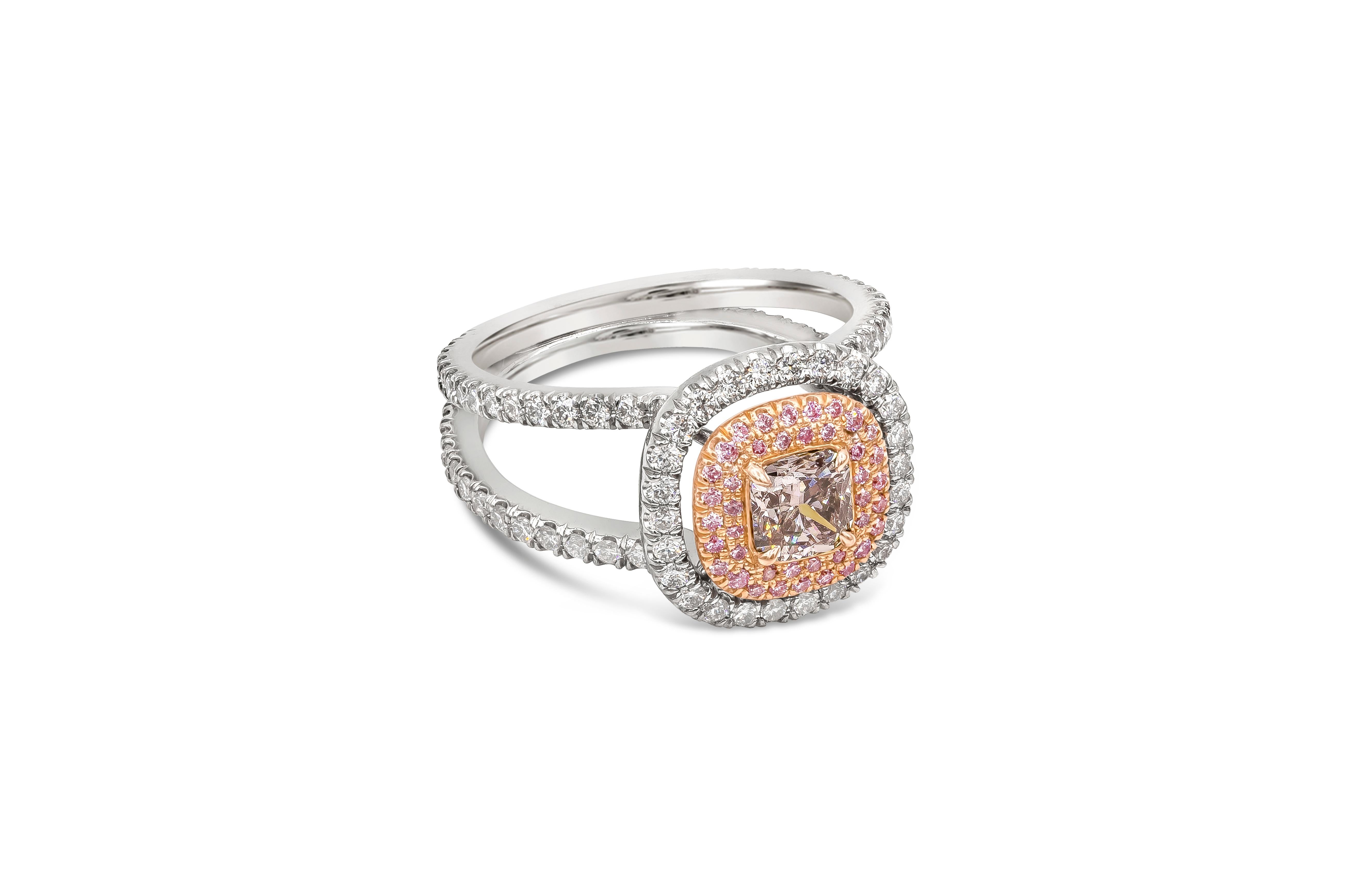 A well-crafted engagement ring showcasing a 0.63 carat cushion cut diamond certified by GIA as Fancy Pink-Brown color set in 18K rose gold. Set in a double halo setting mounting of pink and white diamonds, in a diamond encrusted split shank band