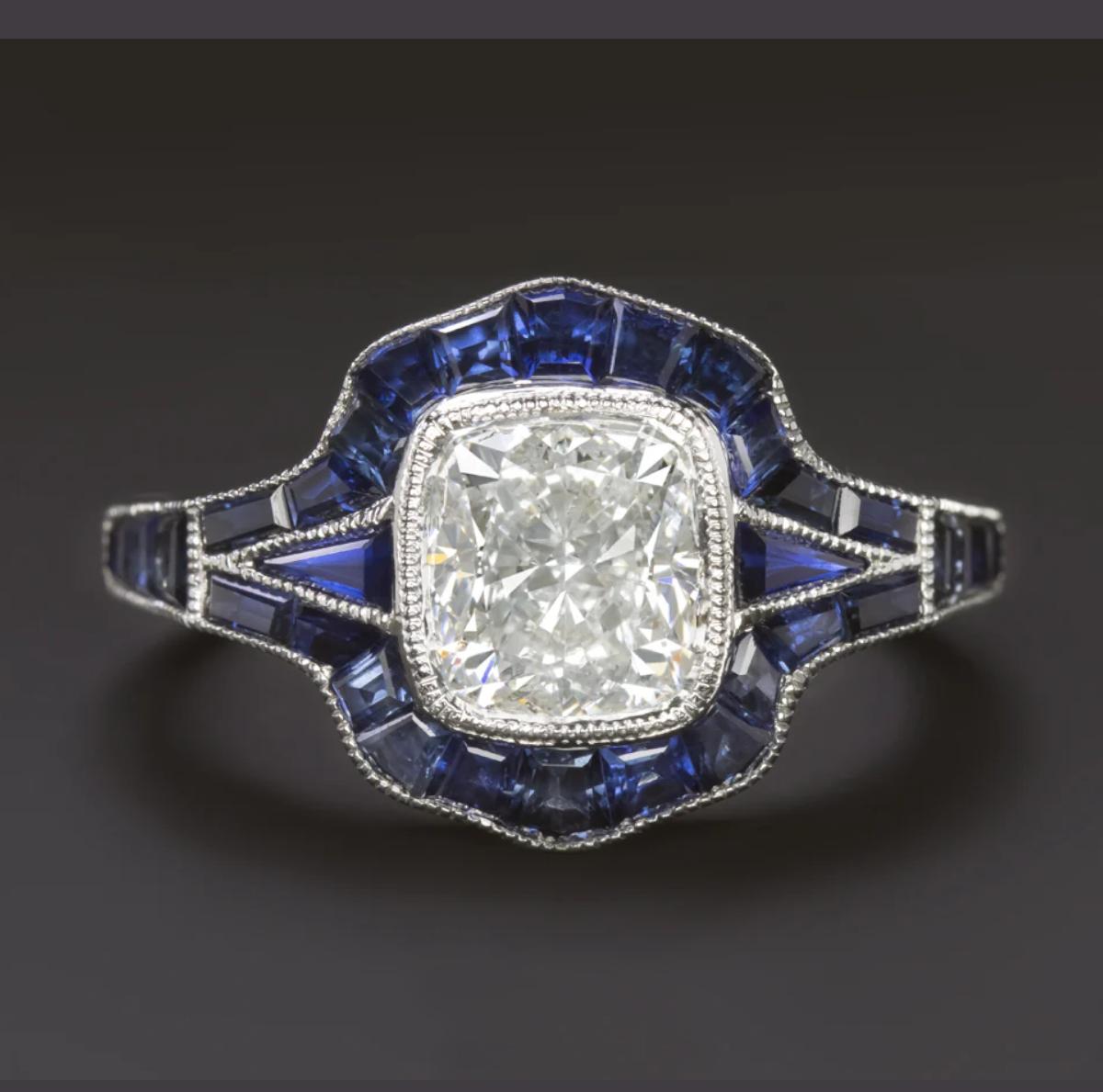 Inspired by timeless Art Deco design, this elegant ring features a stunning 1.90 carat cushion cut diamond at its center, GIA certified with G color and SI2 clarity. The diamond faces up bright white and is completely eye-clean, offering brilliance
