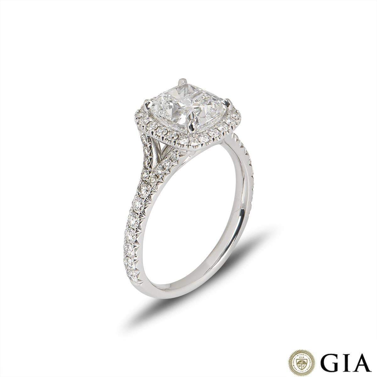 A stunning white gold cushion cut diamond engagement ring. The ring comprises of a cushion cut diamond in a halo setting with a weight of 2.14ct, F in colour and VS1 clarity. The round brilliant diamonds in the halo setting have a total weight of
