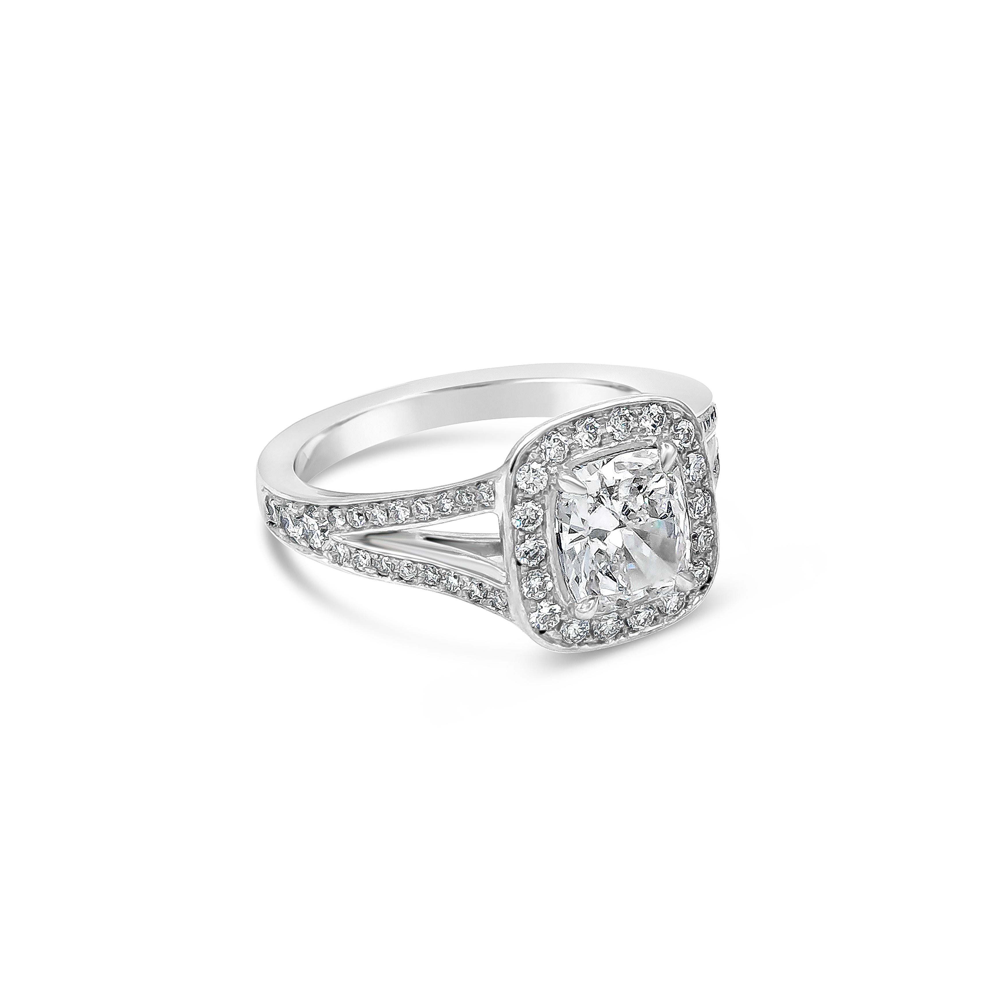 A chic and modern engagement ring style showcasing a 1.22 carat cushion cut diamond center stone, certified by GIA as D color and SI1 in clarity. Set in a halo bezel setting accented with diamonds weighing 0.50 carats total in a split-shank half