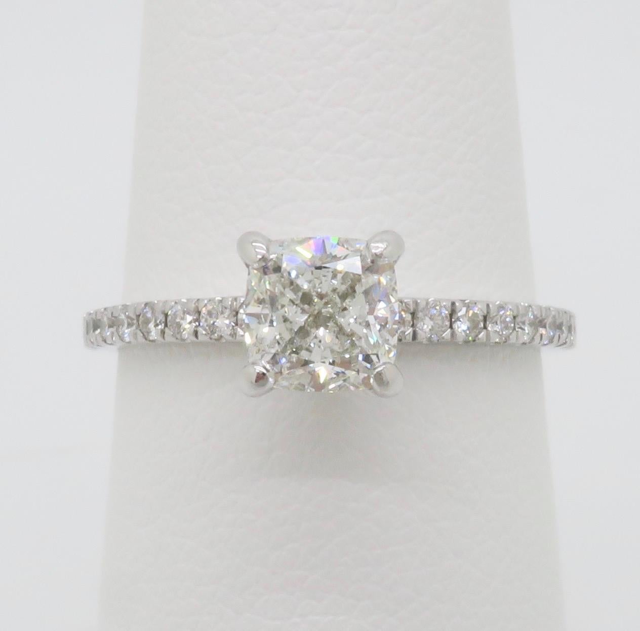 GIA certified Earth Mined Cushion cut diamond engagement ring in 14k white gold. 

Center Diamond Carat Weight: 1.00CT 
Center Diamond Cut: Cushion
Center Diamond Color: H
Center Diamond Clarity: SI2
GIA Report: 7231173198
Accent Diamonds: Round
