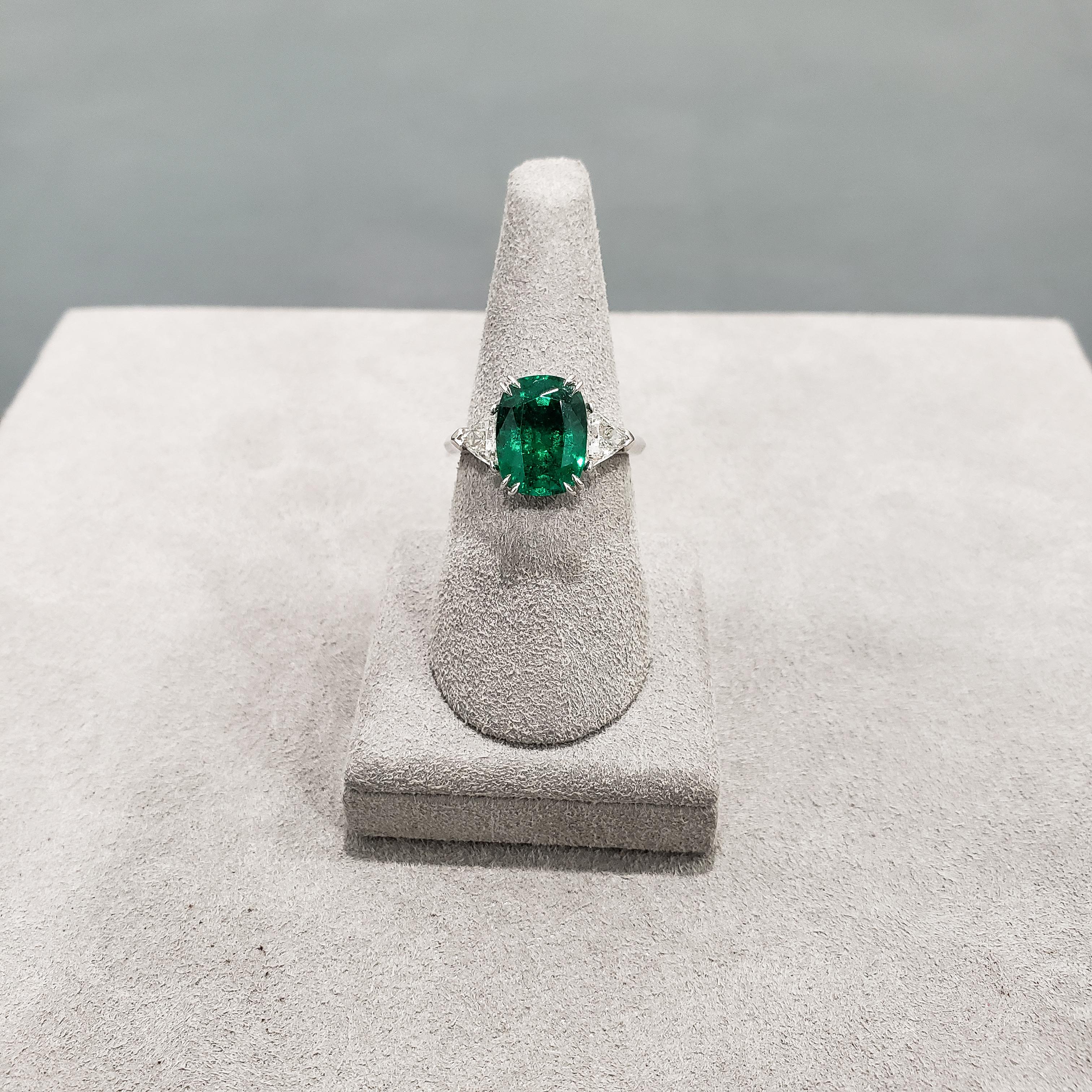 emerald three stone engagement ring
