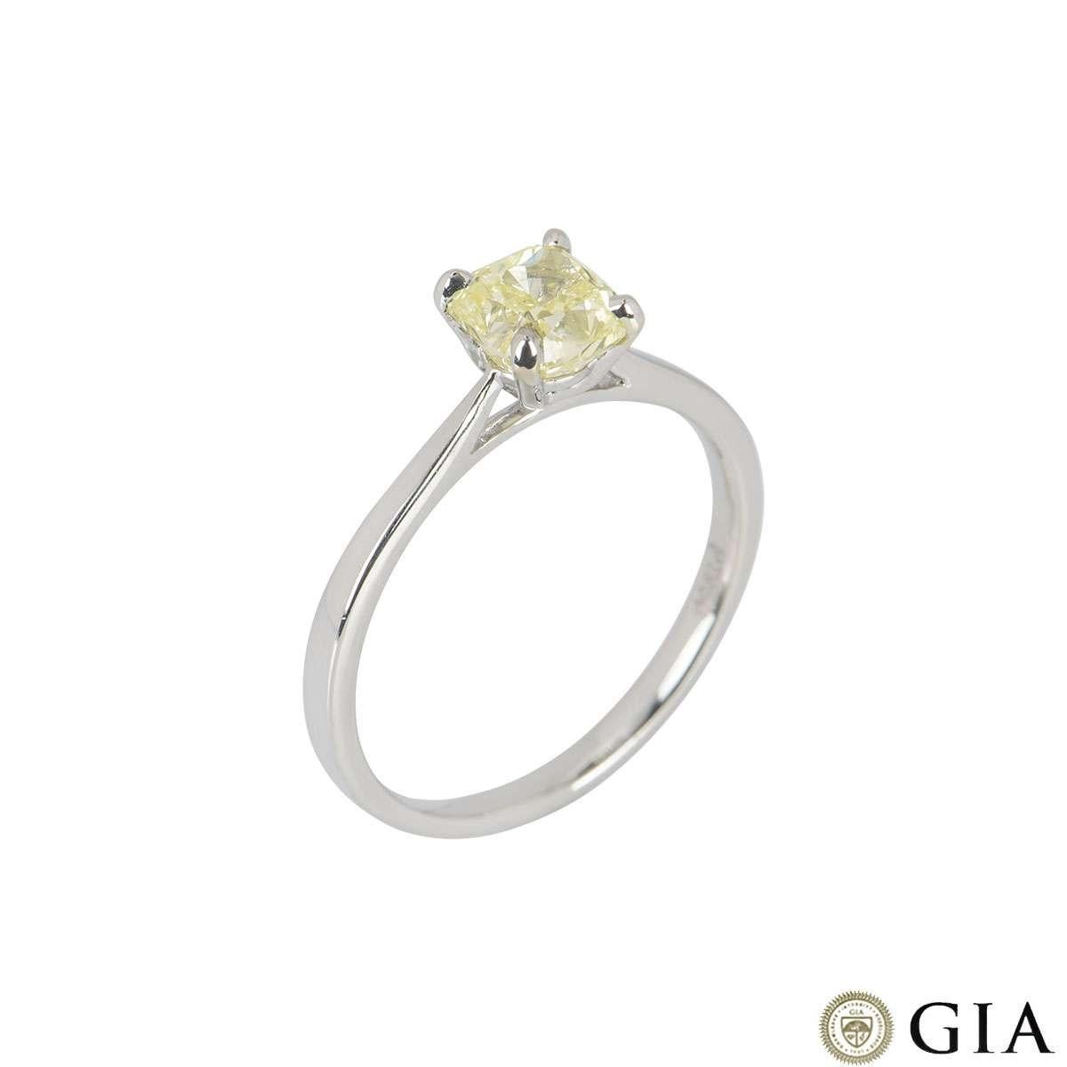 A platinum natural fancy yellow diamond ring. The ring features a cushion cut diamond set to centre in a four claw setting. The diamond has a weight of 1.03ct with a fancy yellow colour with even distribution. The ring is currently a size UK M½, EU