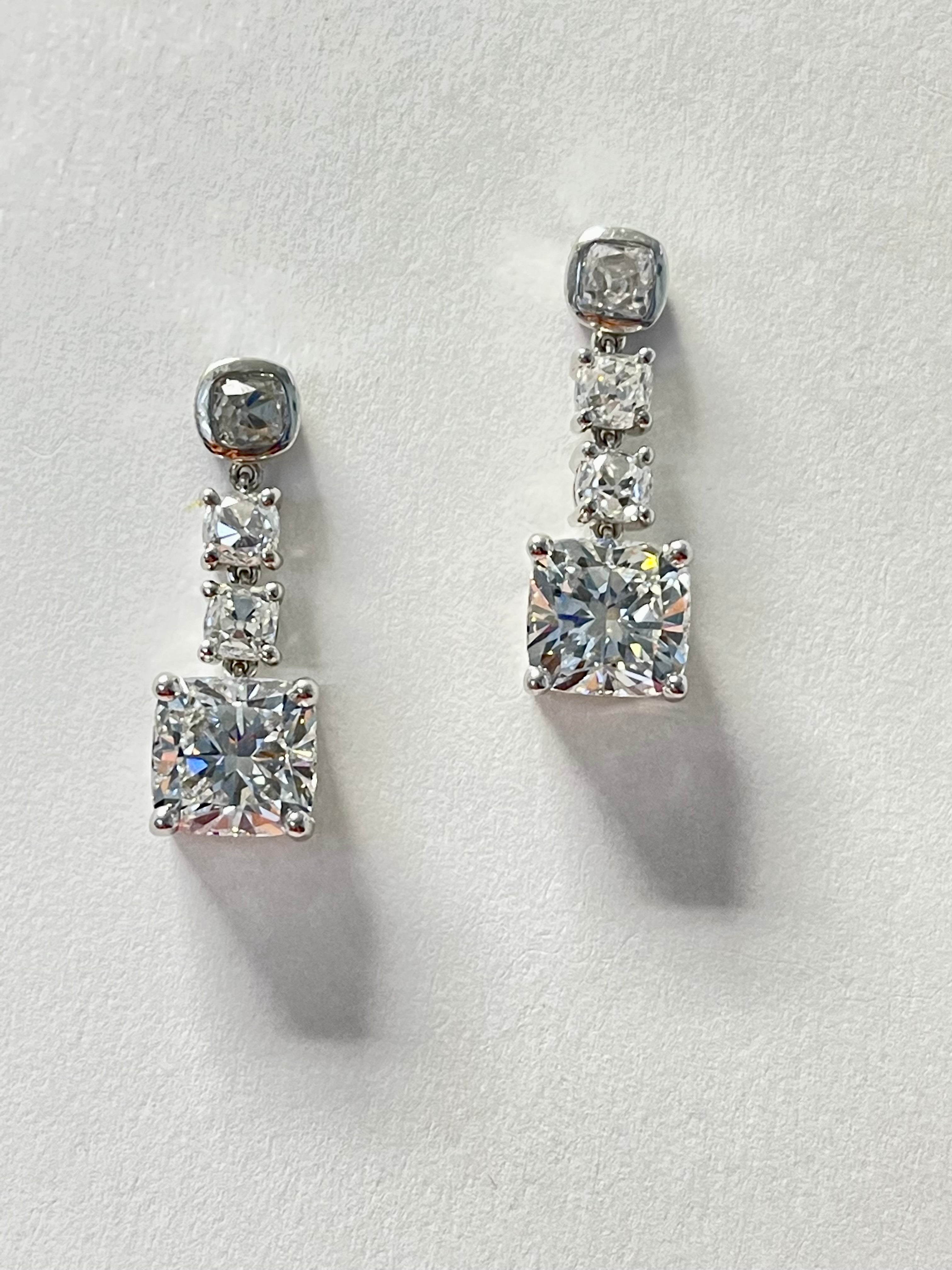 Contemporary GIA Certified Cushion Diamond Three Stone Dangle Earrings In Platinum. For Sale