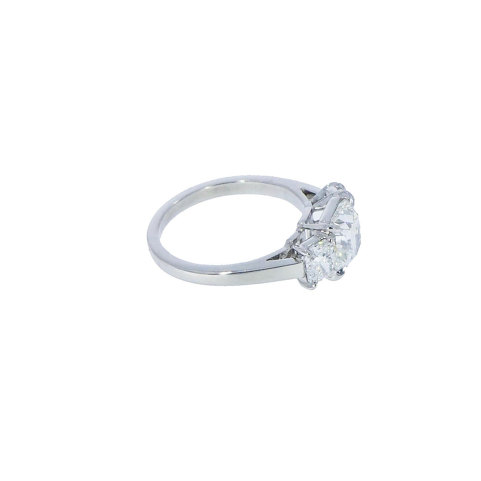 This 3 stone Diamond Engagement Ring features a GIA certified Cushion shaped Diamond at the center, weighing 2.01 carat, G color, SI1 clarity.
The diamonds at each side are 0.48 carat of the same color and clarity as the center Diamond.
Set in a