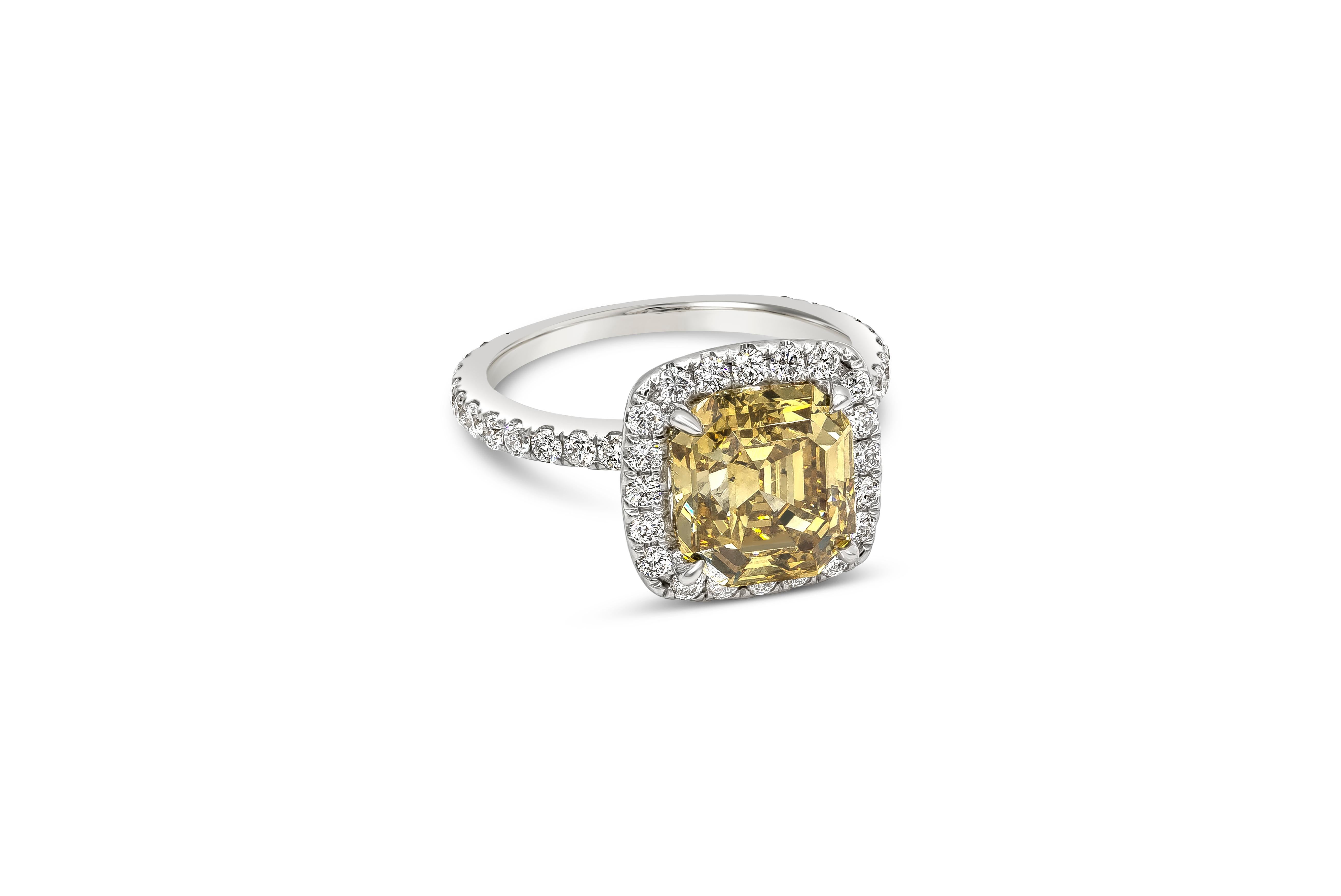 This elegant and luxurious engagement ring featuring 4.27 carat square asscher cut diamond certified by GIA as fancy deep brownish yellow color, SI1 clarity. Surrounding the center are round brilliant diamonds in a polished platinum band. Accent
