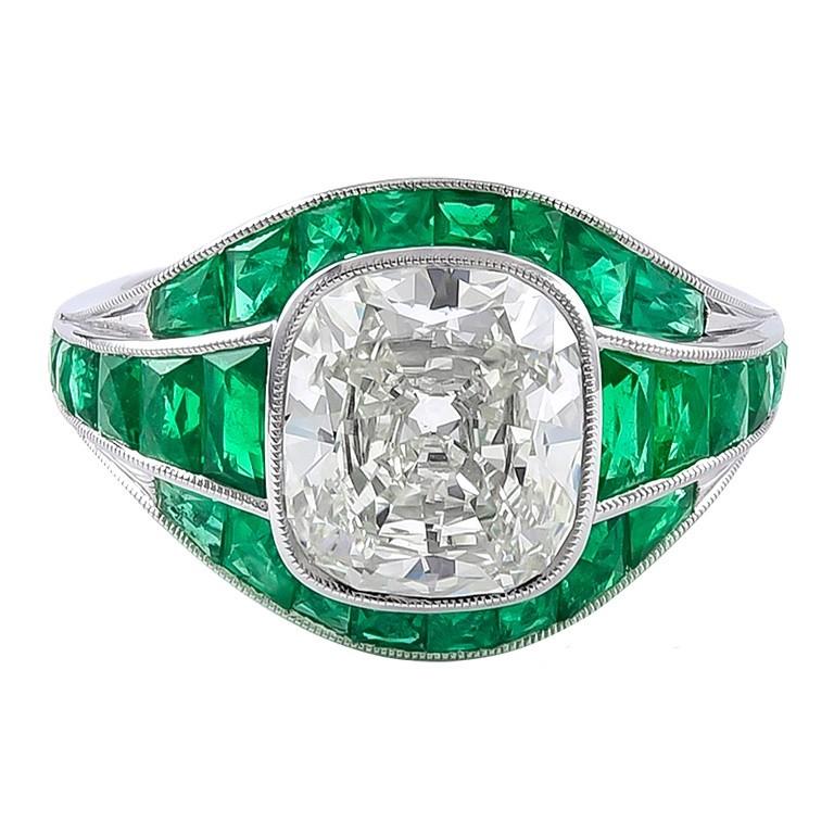 Lovely Art Deco Inspired Ring!

This particular art deco styled ring consists of beautiful cushion brilliant cut diamond 2.87 carat surrounding with fine quality french cut emeralds total weighing 1.40 carat. 