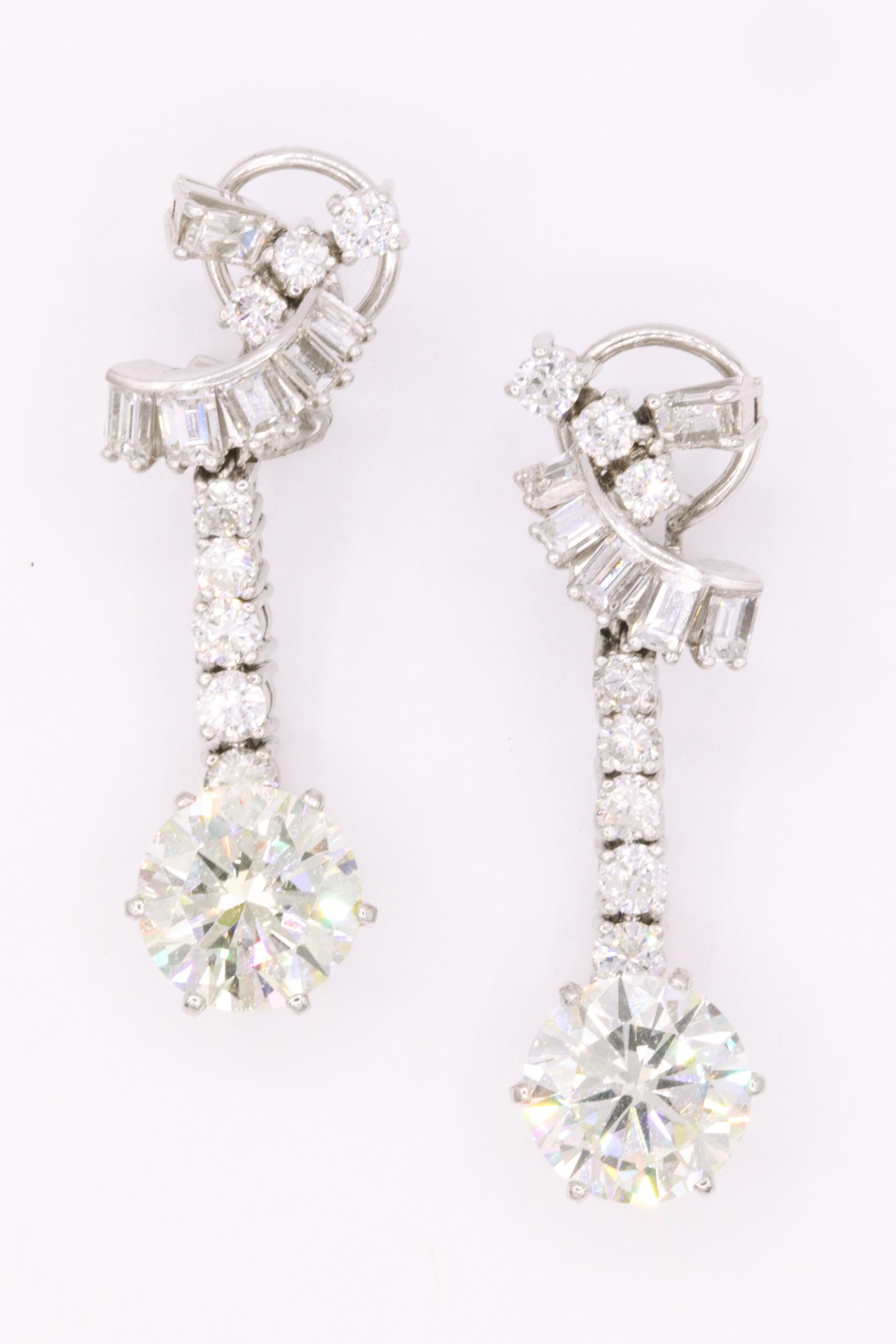 GIA Certified drop earrings featuring two round brilliants weighing a total of 8.80 Carats. 
Color N-O
Clarity VS2-SI1 