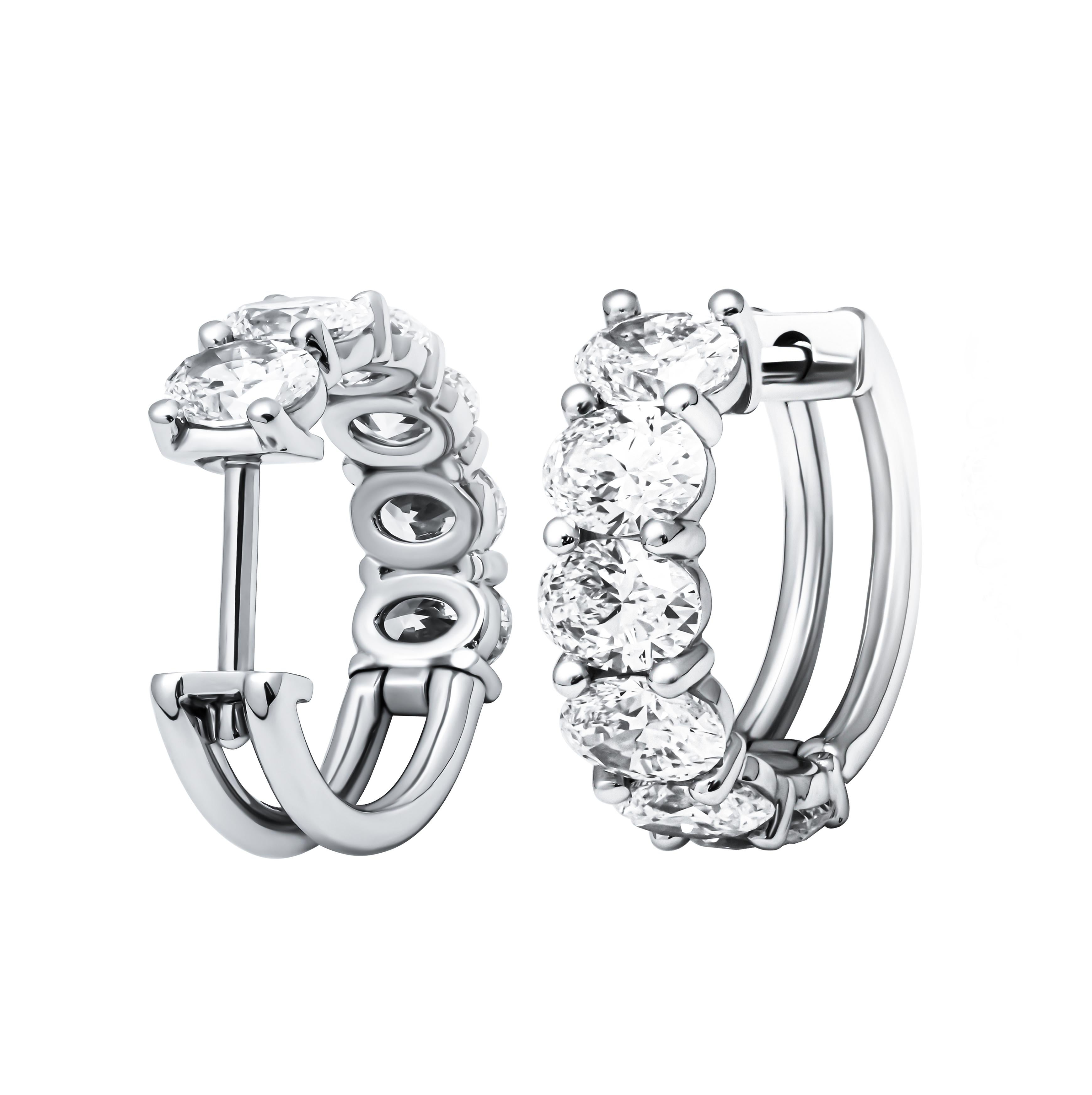 These Oval Diamond Hoop Earrings exude timeless elegance and luxury. Crafted from lustrous platinum, they boast a design that seamlessly blends classic sophistication with contemporary style. Each hoop is adorned with twelve dazzling oval-cut
