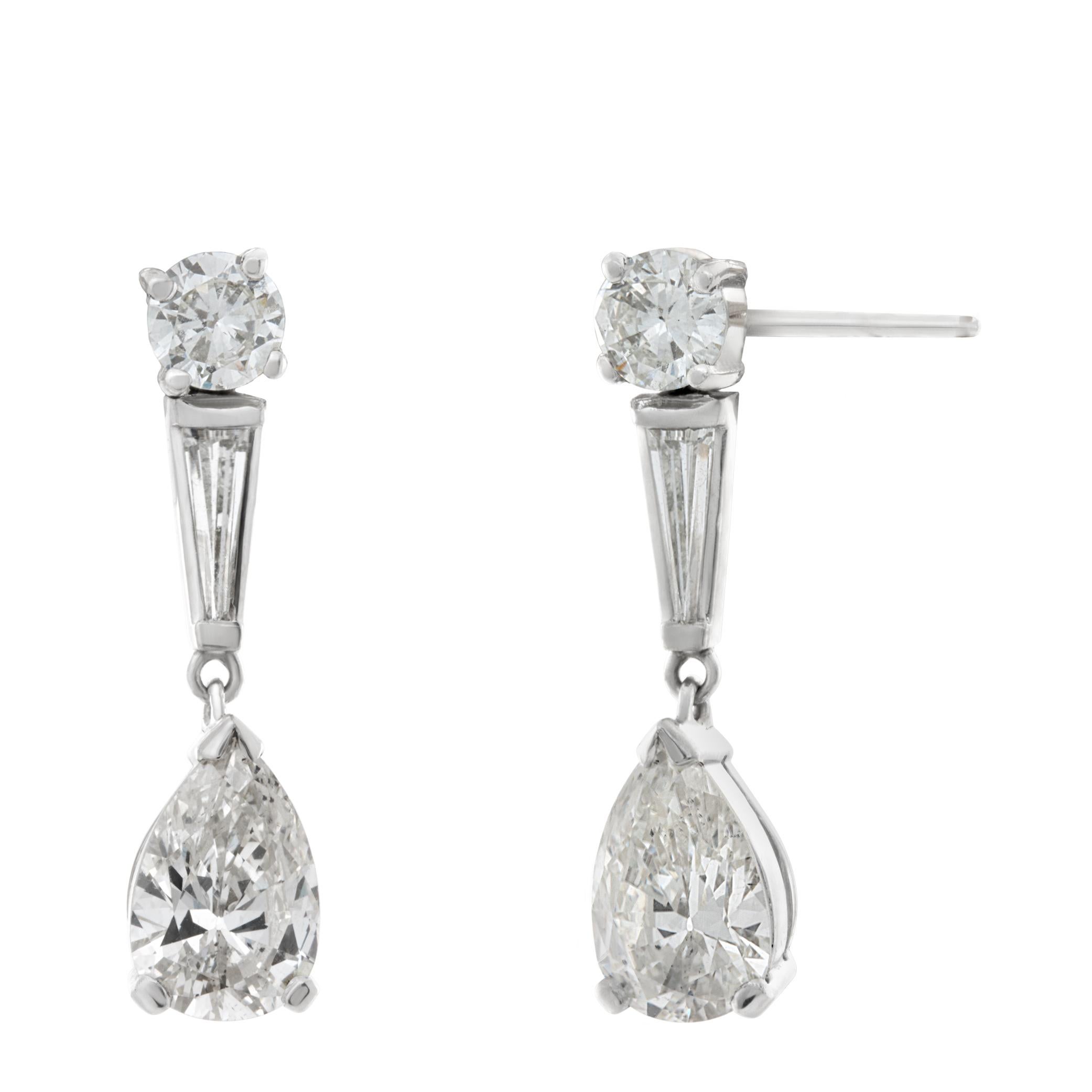 GIA Certified Pear shaped diamond earrings in platinum and 14k white gold. One pear shaped diamond is 1.20 cts (I color, SI1 clarity) and the other is 1.27 cts (J color, SI1 clarity). Additional diamonds are two 0.33 carat round diamonds & two 1