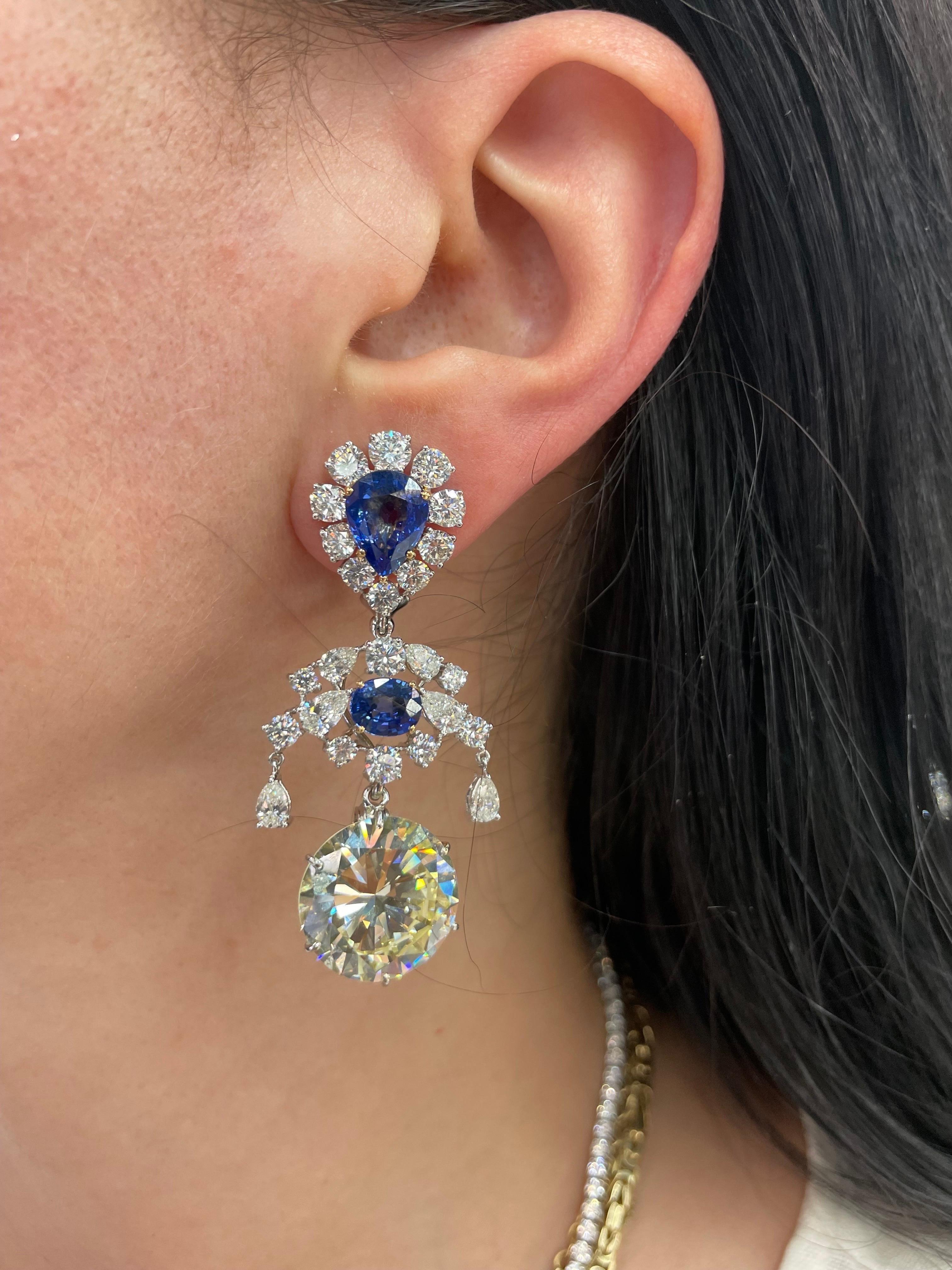 GIA Certified drop earrings featuring two Round Brilliants weighing each 15.08 Carats with a top design of Pear and Oval cut natural Sri Lanka Sapphires, in 18 karat white gold. 
Pear Shape Sapphires approximately 5 carats each 
Oval Shape Sapphires