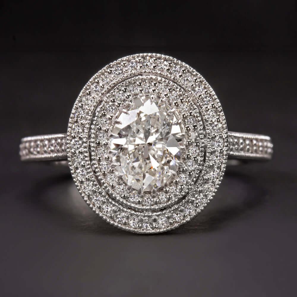 1.00 carat GIA certified diamond surrounded by a glittering double diamond halo. Measuring an eye catching 14.5mm across, the ring has a stunningly large look! The bright white and completely eye clean center diamond displays lively brilliance! The