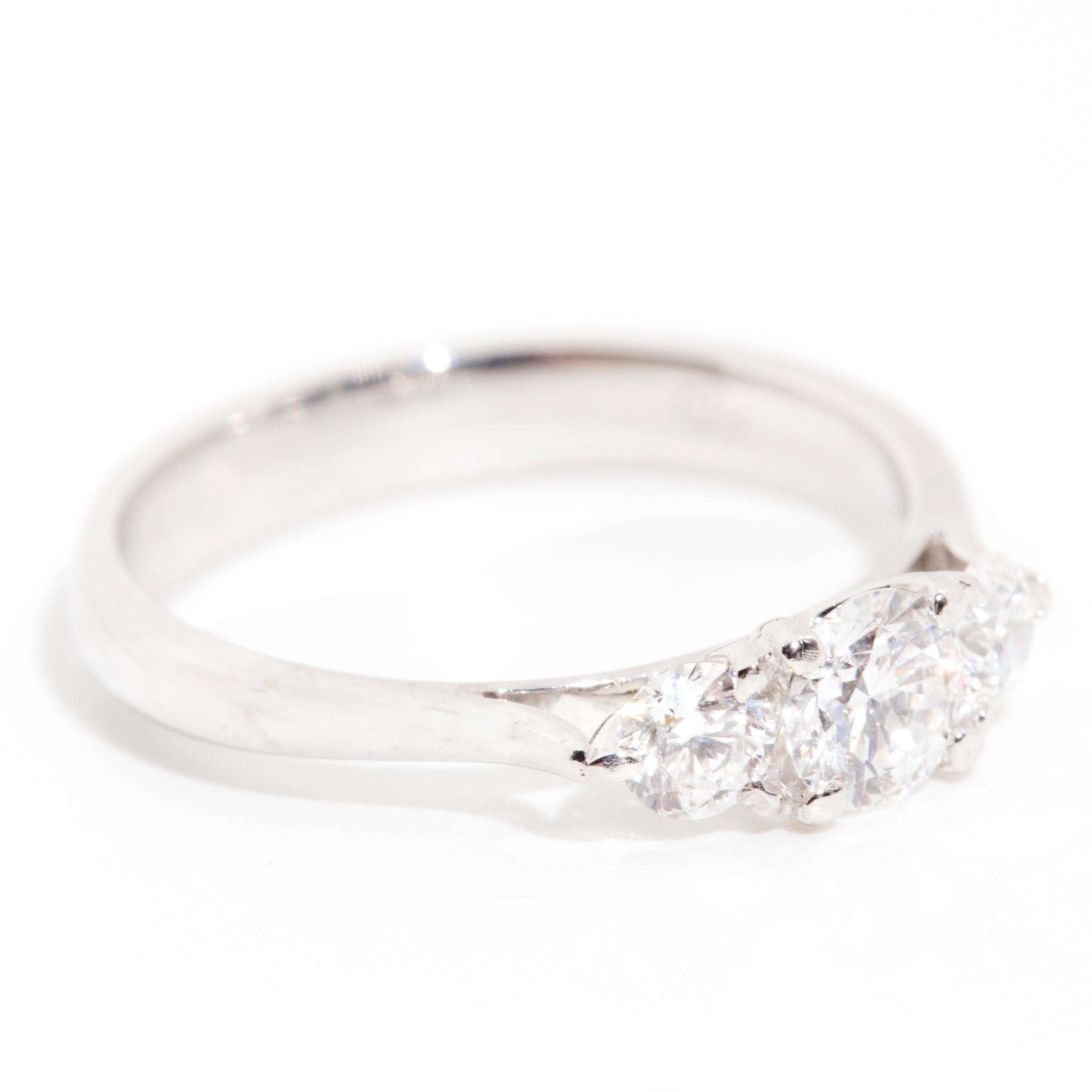Forged in 18 carat white gold, this vintage three stone engagement ring features a stunning centrepiece 0.40 carat certified round brilliant cut diamond flanked by two alluring round brilliant diamonds. We have named this wondrous ring The Elsa