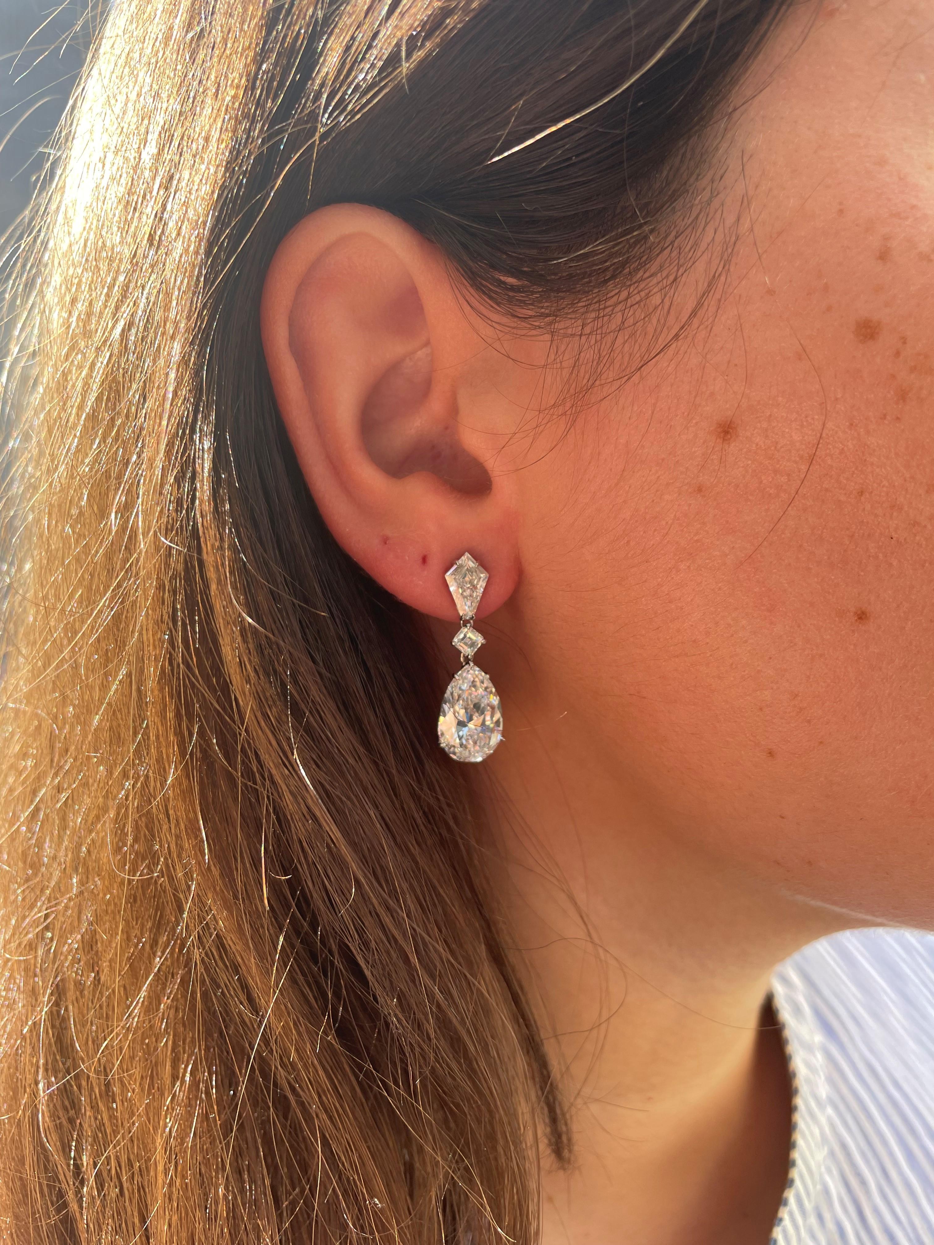 An absolutely gorgeous statement piece, these earrings are perfect for black tie wedding or elegant gala. This incredible pair of diamond drop earrings feature a matched pair of spectacular GIA certified E color, VS2 clarity pear shape diamonds,