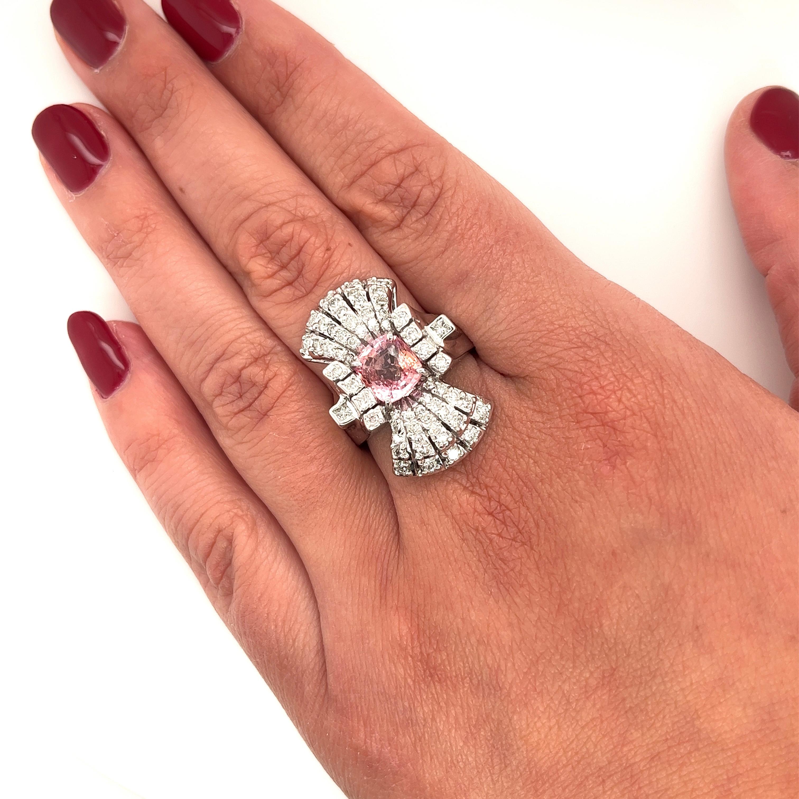 18 karat white gold Edwardian era-inspired Pink Sapphire and Diamond cluster vertical ring. GIA certified with Sapphire origin report and ring description. Both the center stone and the diamonds are radiating with brilliance and sparkle. The