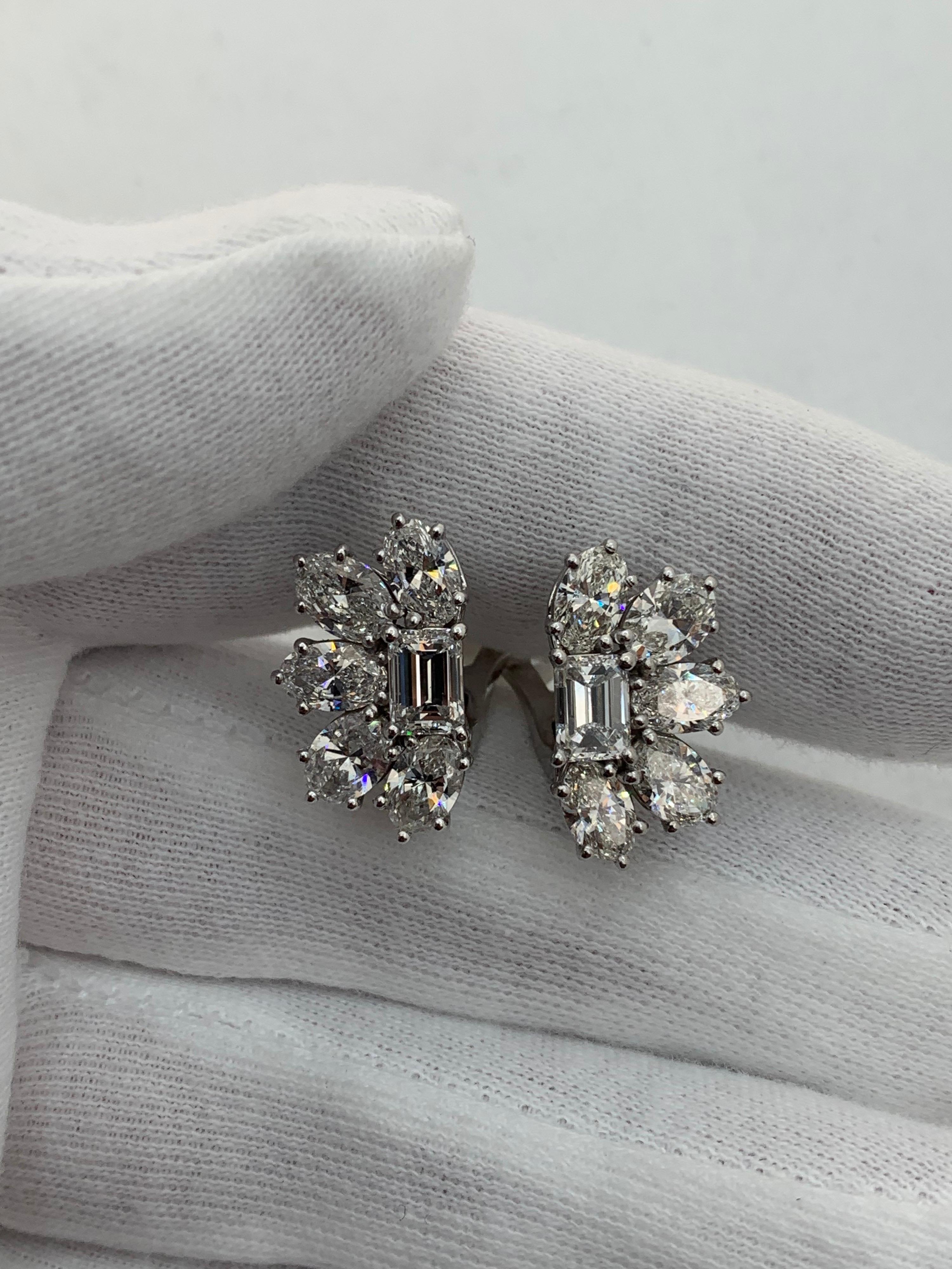 Sophisticated Statement Earring!!

Emerald Cut Diamonds weighing 1.55 Carat graded as D color and VS2, VVS1 clarity.
Oval Diamonds weighing 4.38 Carats and graded by GIA as D-G color and VVS1-SI2 Clarity.
Set in Platinum and 18 Karat White